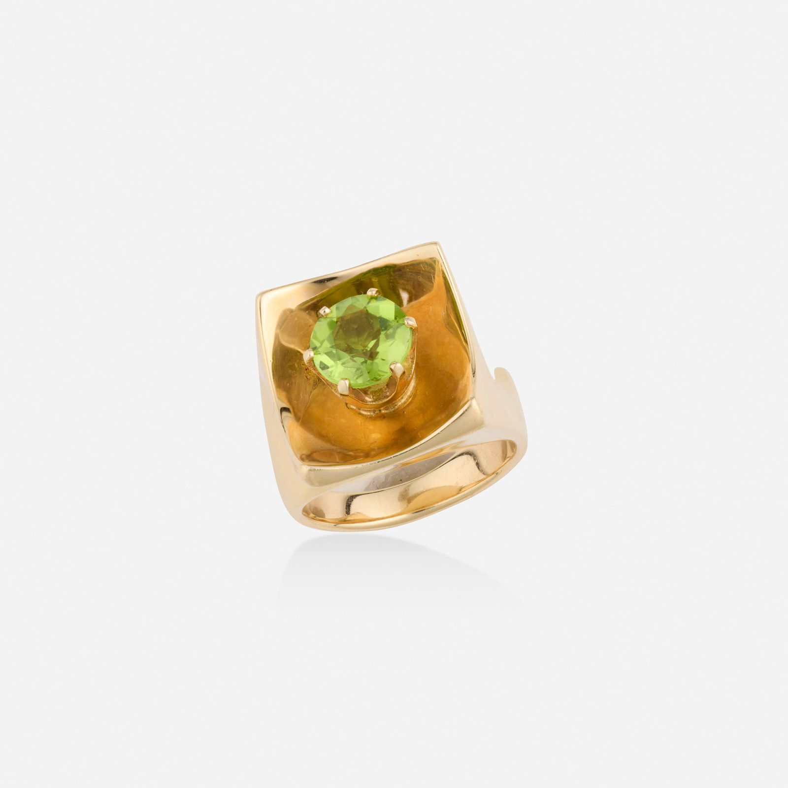 Peridot and gold ring: Peridot and gold ring Of sculptural design, set with a circular-cut peridot 14k yellow gold Ring size 6; Gross weight 11.6 dwts This work will ship from Lambertville, New Jersey.