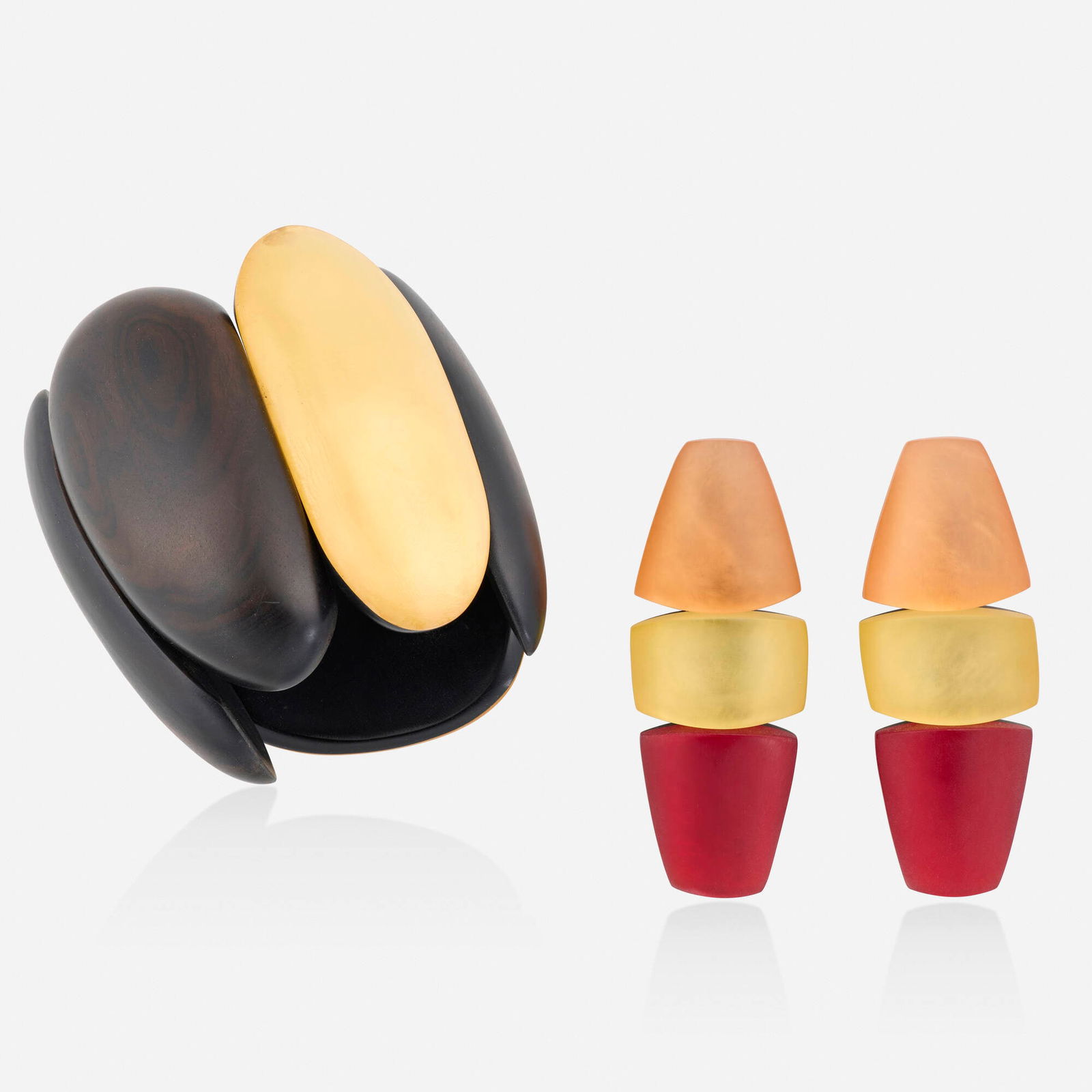 Monies, Lucite earrings and bracelet: Monies Lucite earrings and bracelet Each designed with large pieces of Lucite, the bracelet additionally with wood Base metal Signed Monies to each example Bracelet inner circ. 6.50 in, width 3.50