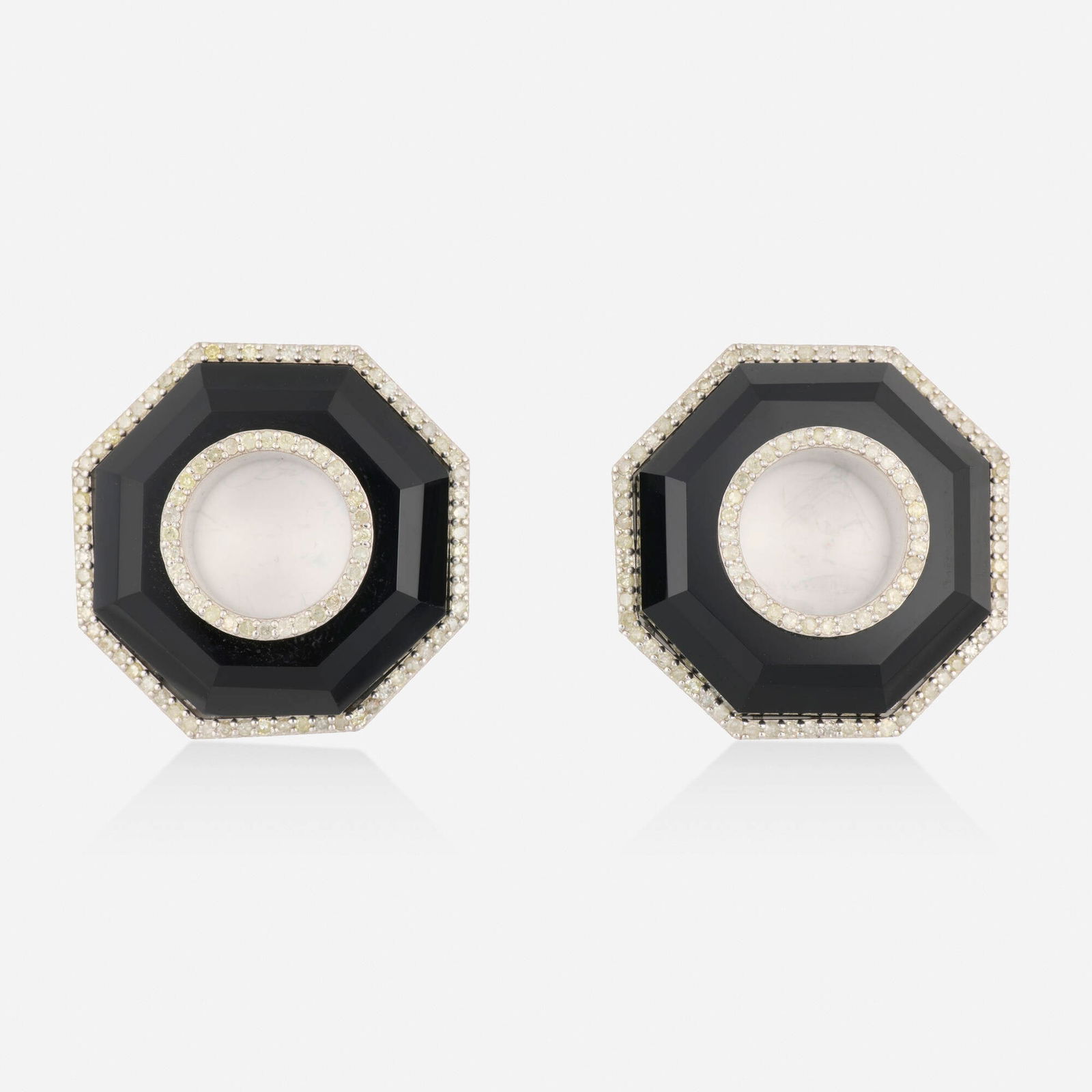Black onyx and diamond earrings: Black onyx and diamond earrings Each of geometric design, set with a faceted black onyx and single-cut diamonds Silver and yellow gold 1.125 x 1.125 in; Gross weight 16.0 dwts This work will ship