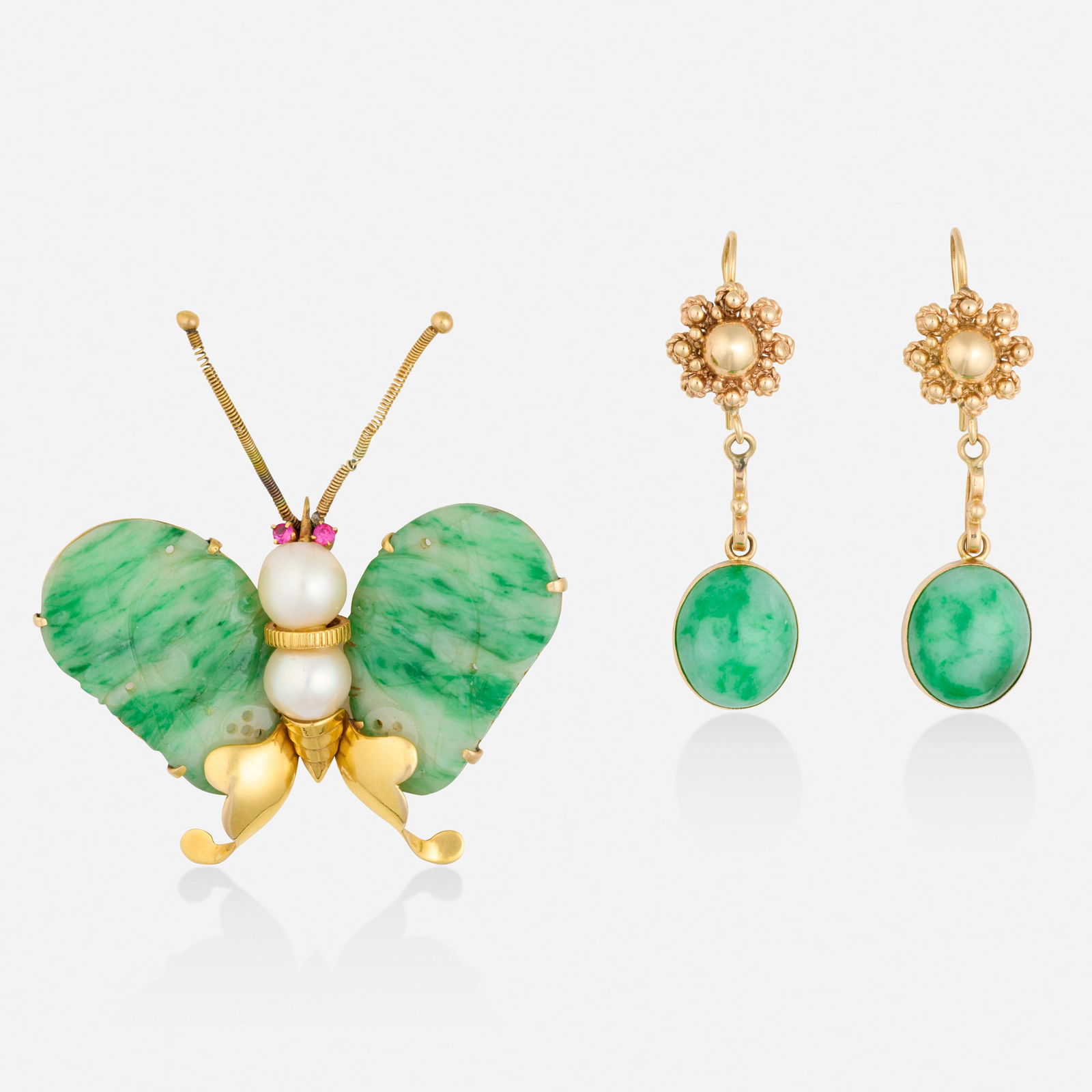 Group of jadeite and gold jewelry: Group of jadeite and gold jewelry Comprising a butterfly brooch with carved jadeite wings, cultured pearl body, and circular-cut ruby eyes; together with a pair of gold floret earrings set with