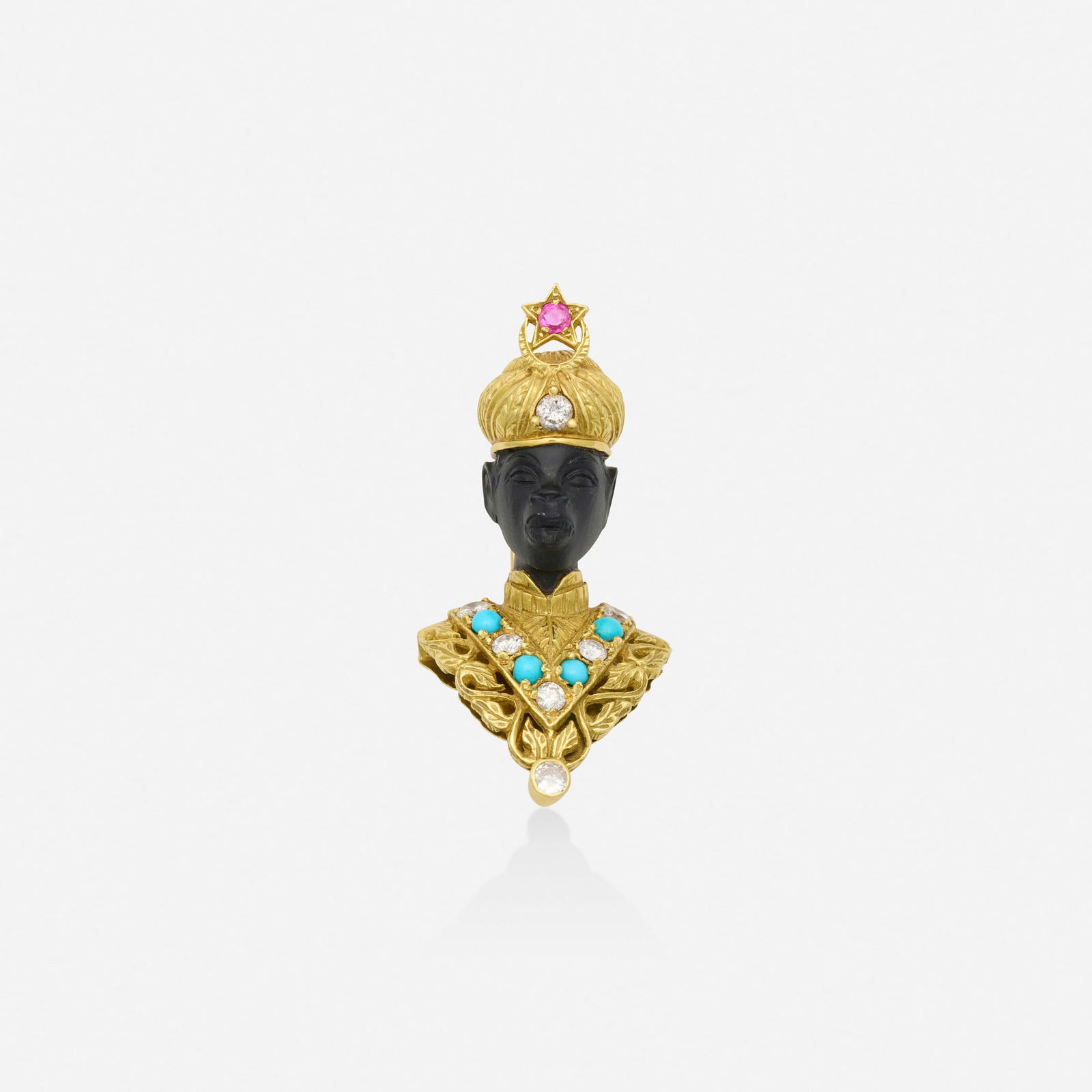 Blackamoor brooch: Blackamoor brooch The carved ebony figure with round brilliant-cut diamond and cabochon turquoise chest, circular-cut ruby and round brilliant-cut headdress 18k yellow gold 1.875 x 0.875 in; Gross
