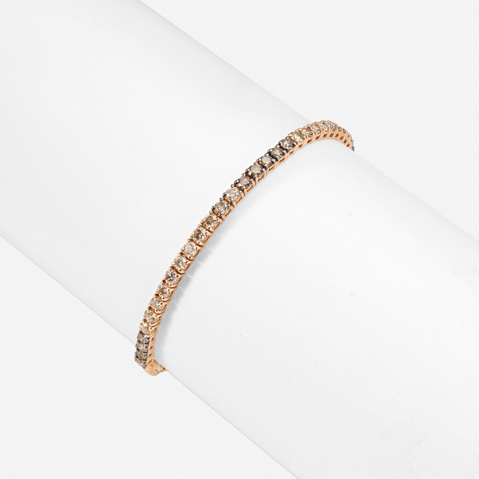 Diamond and pink gold bracelet: Diamond and pink gold bracelet Set with ombre round brilliant-cut diamonds 14k pink gold Inner circ. adjustable 4.50-9.50 in; Gross weight 5.0 dwts This work will ship from Lambertville, New