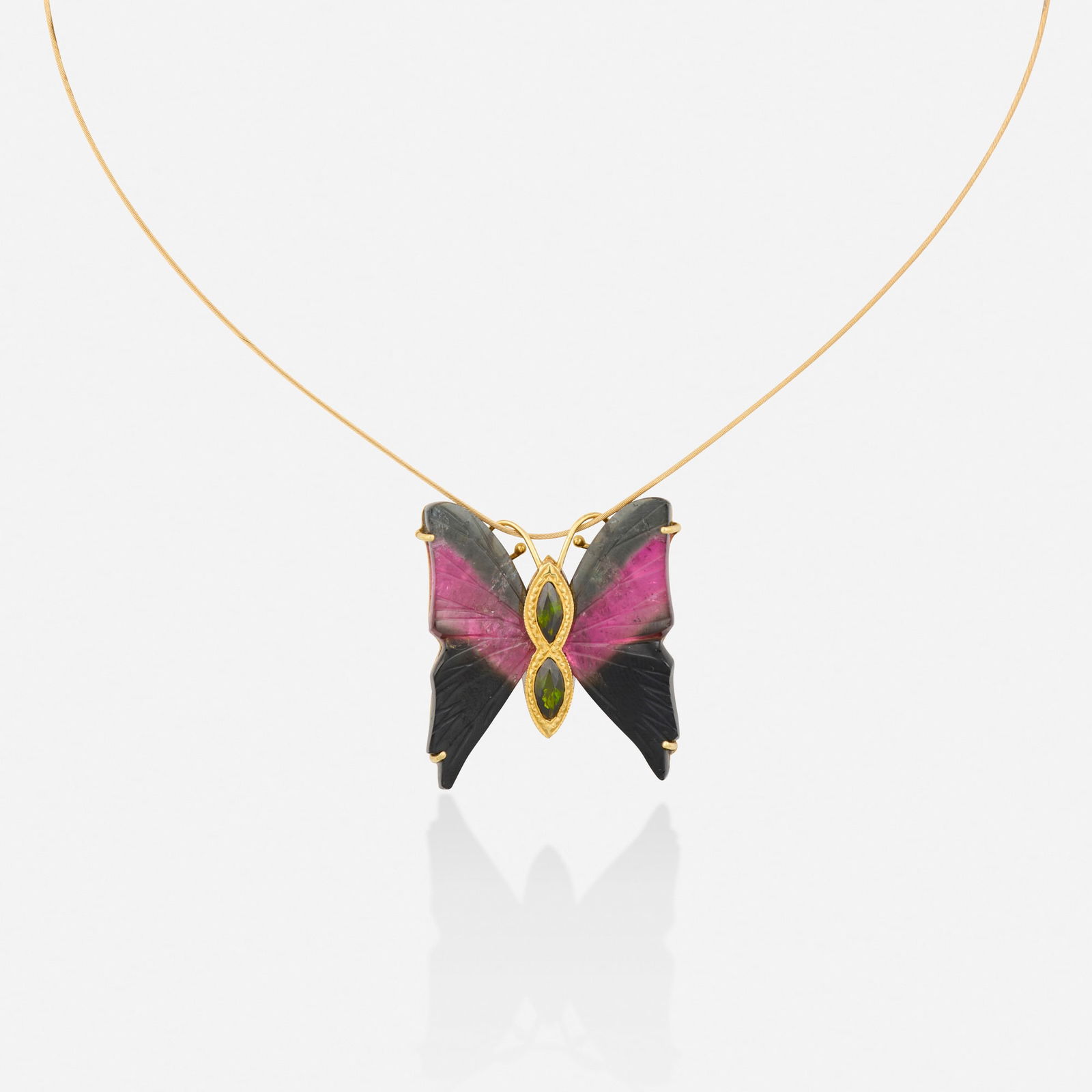 Tourmaline and gold necklace: Tourmaline and gold necklace The butterfly pendant with carved watermelon tourmaline wings and marquise-cut green tourmaline body, suspended from the gold wire 18k and 14k yellow gold Necklace 16