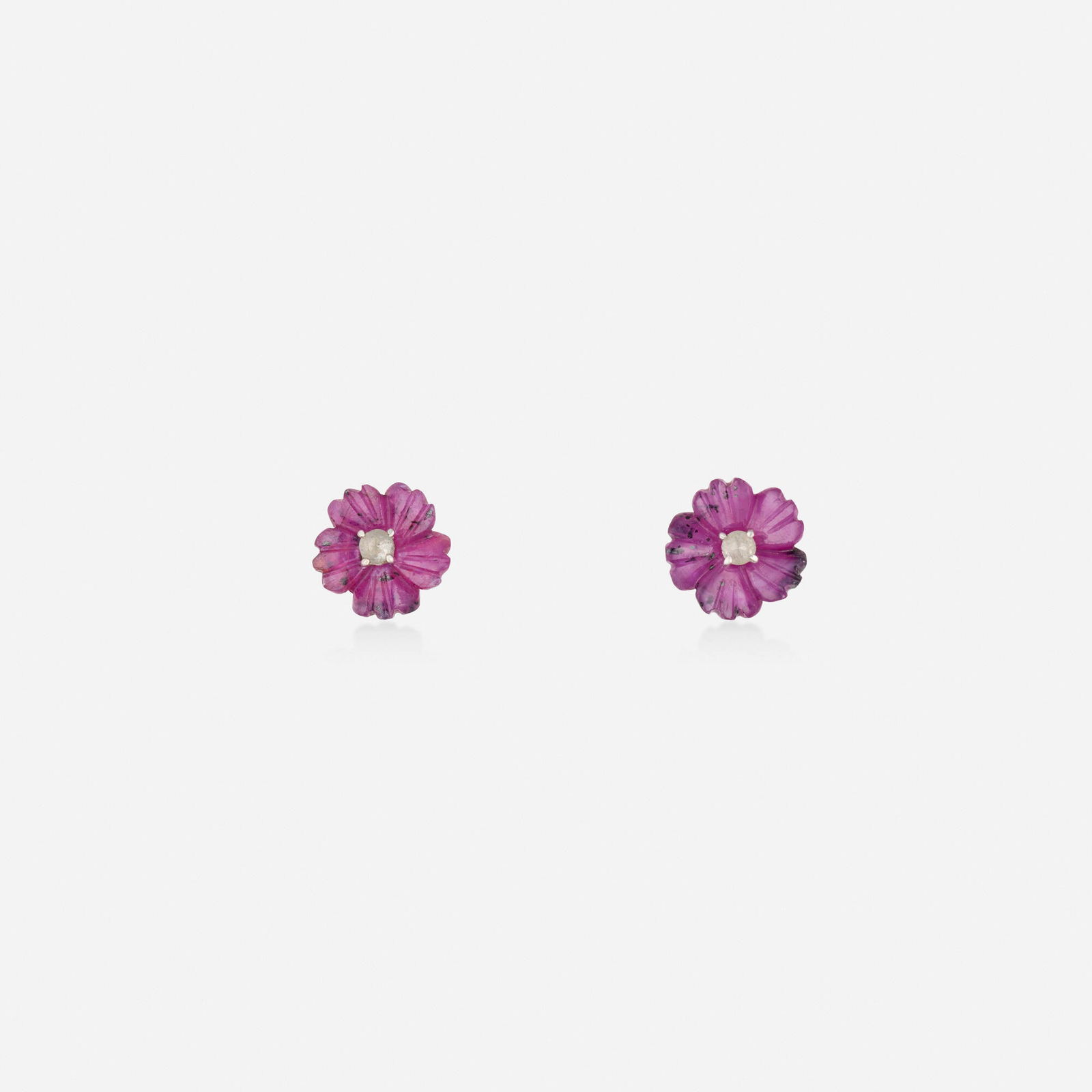 Ruby and diamond earrings: Ruby and diamond earrings Each set with a carved ruby flower with rose-cut diamond center Silver and yellow gold 0.375 in; Gross weight 1.4 dwts This work will ship from Lambertville, New Jersey.