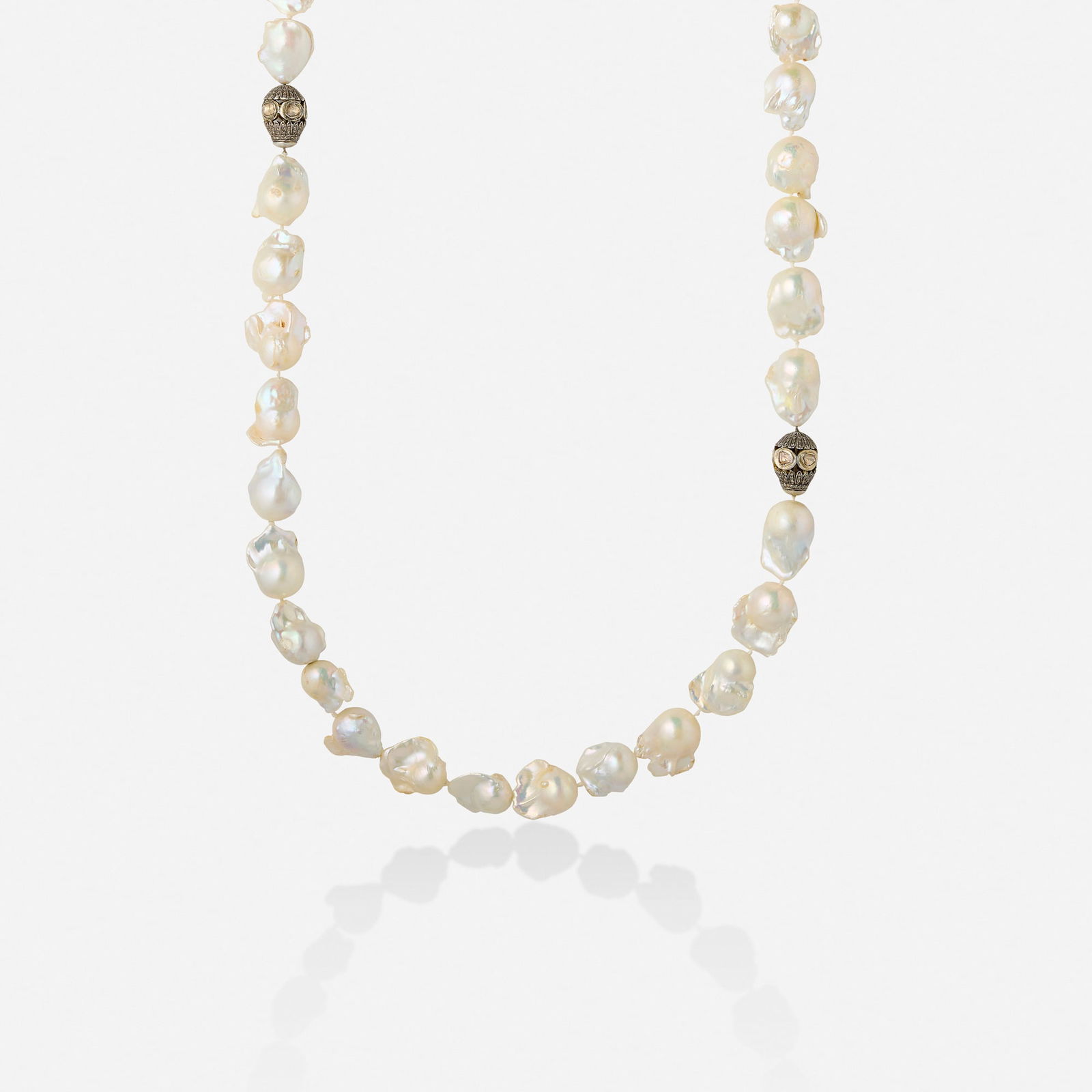 Baroque cultured pearl and diamond necklace: Baroque cultured pearl and diamond necklace Strung with baroque cultured pearls, two stations set with polki and single-cut diamonds; may be worn as one long necklace or two shorter necklaces Silver