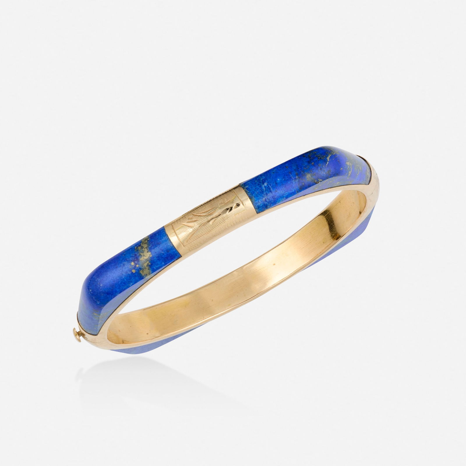 Lapis lazuli and pink gold bracelet: Lapis lazuli and pink gold bracelet The hinged bangle bracelet, set with carved lapis lazuli 14k pink gold Inner circ. 6.75 in, width 0.25 in; Gross weight 13.8 dwts This work will ship from