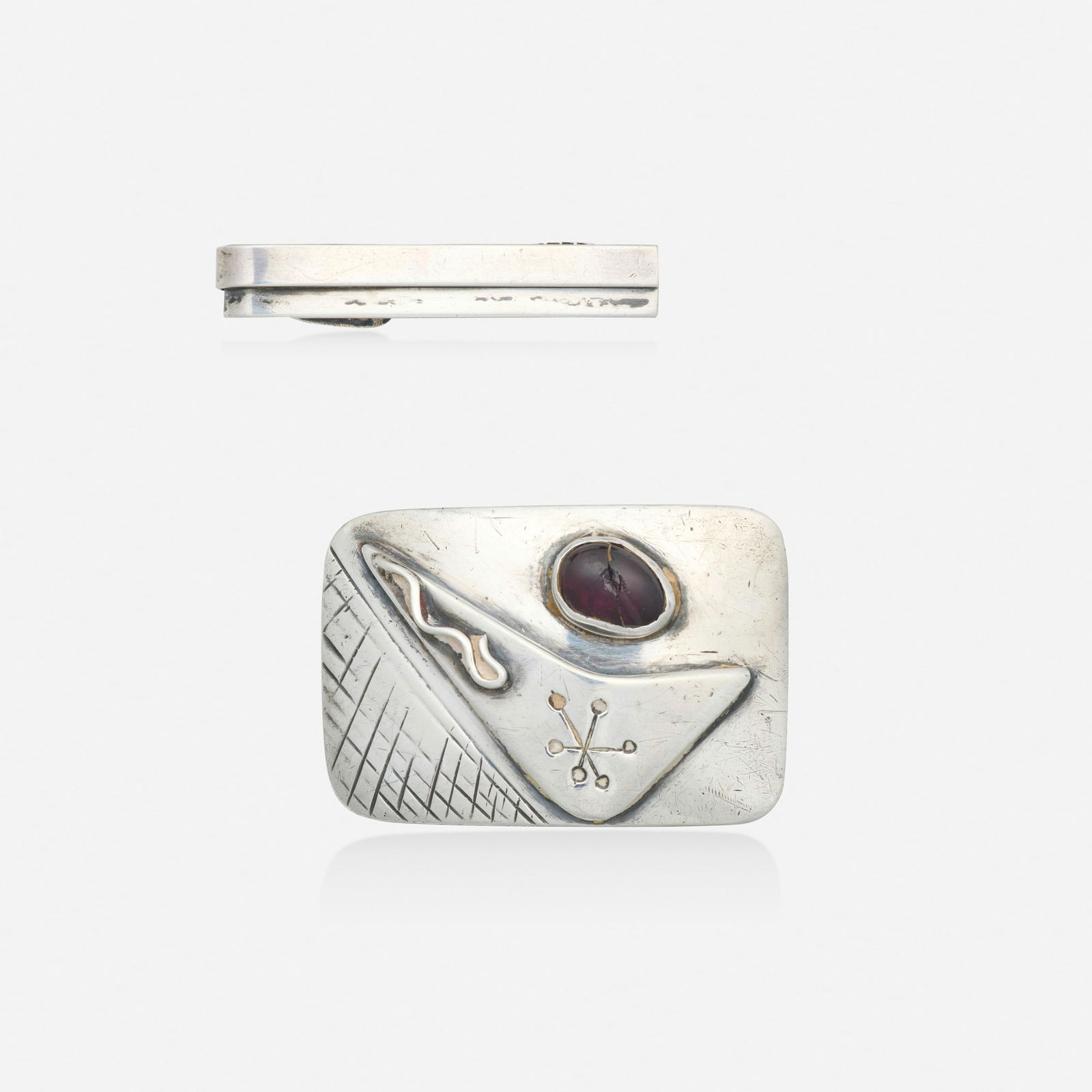 Ed Wiener, Silver and garnet belt buckle with tie bar: Ed Wiener Silver and garnet belt buckle with tie bar Each of abstract design, the belt buckle set with a cabochon garnet Silver 1.75 x 1.25 in and 0.625 x 0.25 in; Gross weight 25.7 dwts Pr