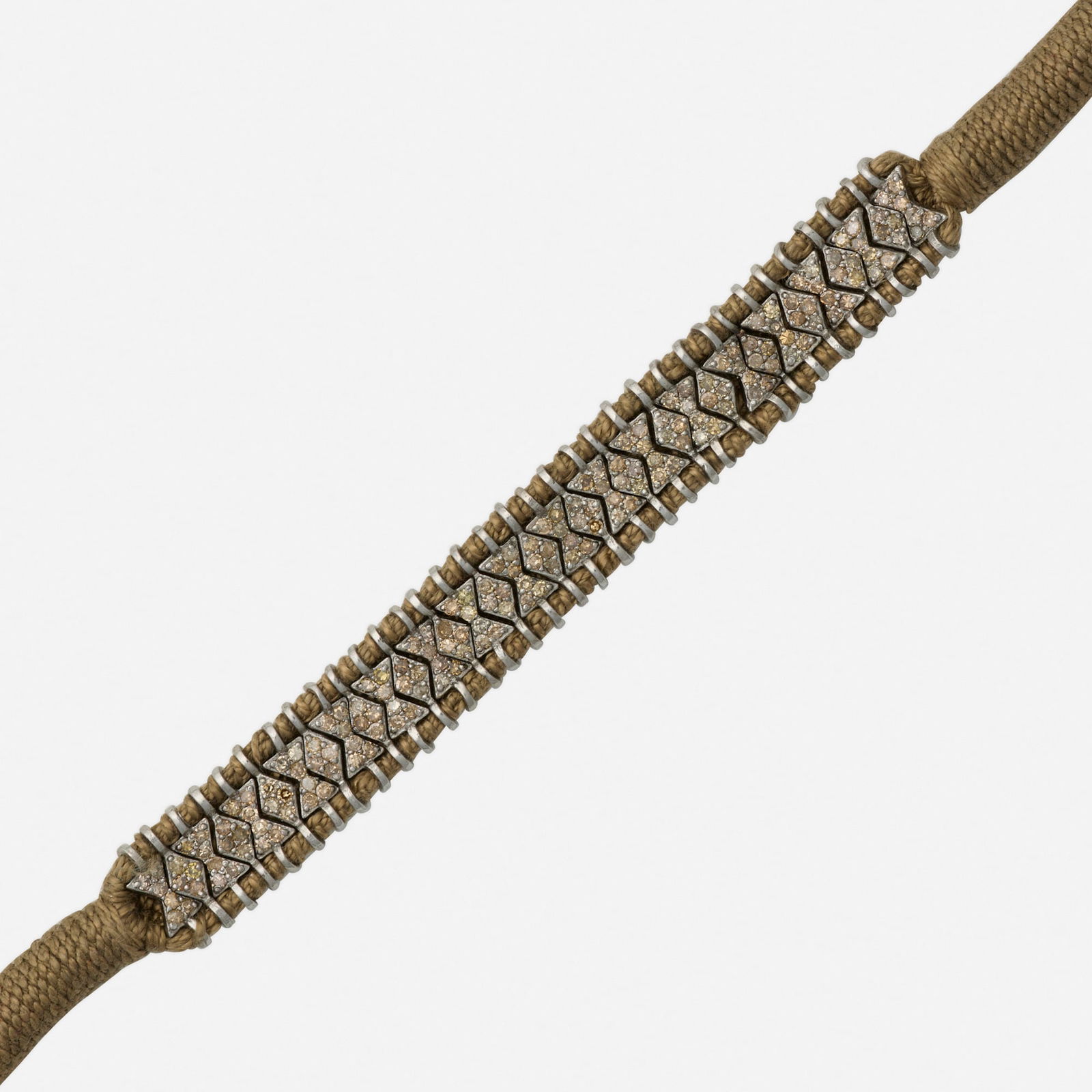 Diamond, cord, and silver bracelet: Diamond, cord, and silver bracelet The flexible bracelet, set with brown single-cut diamond sections on a taupe cord Silver 8 x 0.50 in; Gross weight 9.3 dwts This work will ship from