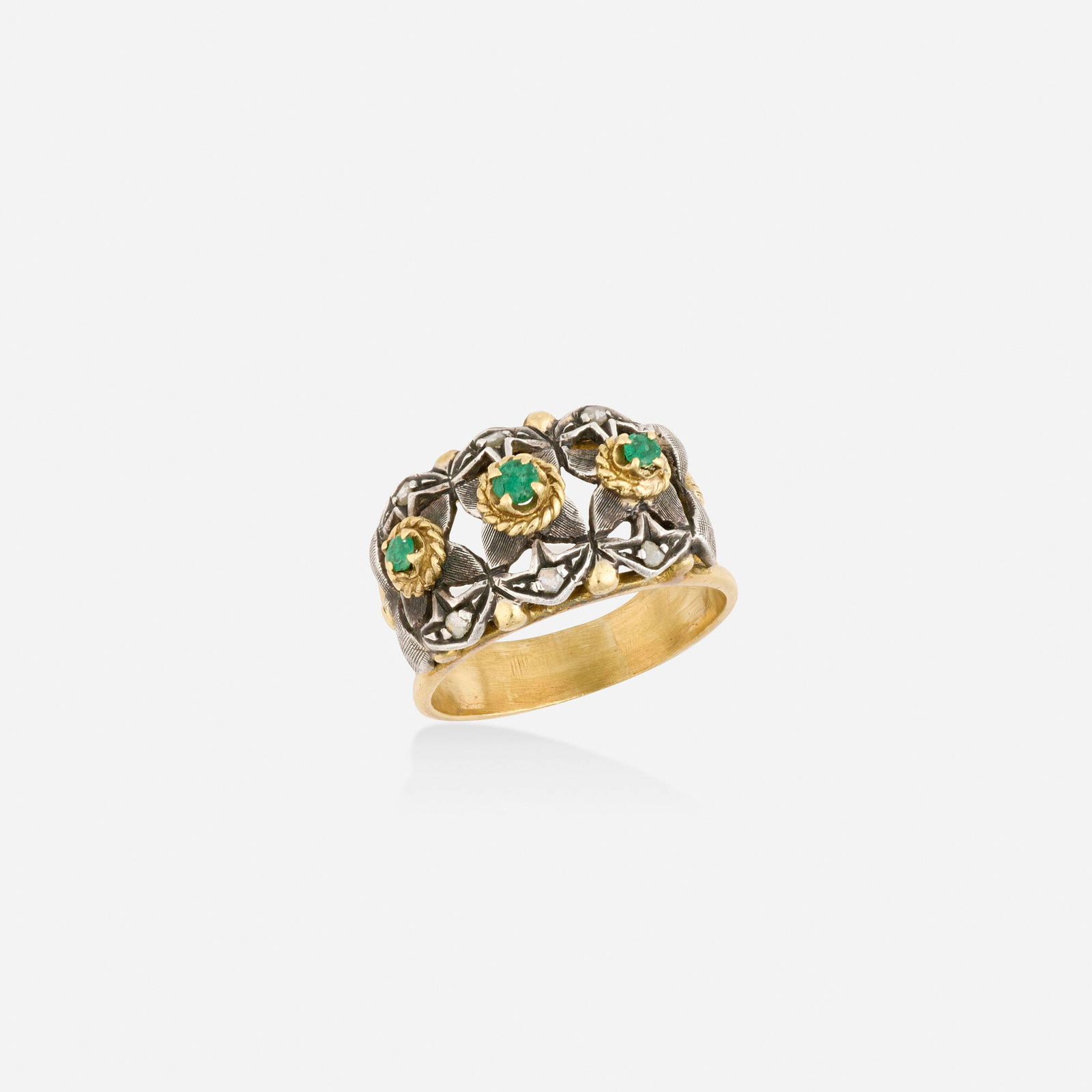 Emerald, diamond, and silver-topped gold ring: Emerald, diamond, and silver-topped gold ring Of foliate design, set with circular-cut emeralds and rose-cut diamonds Silver-topped 18k yellow gold Ring size 7; Gross weight 3.5 dwts This work will sh