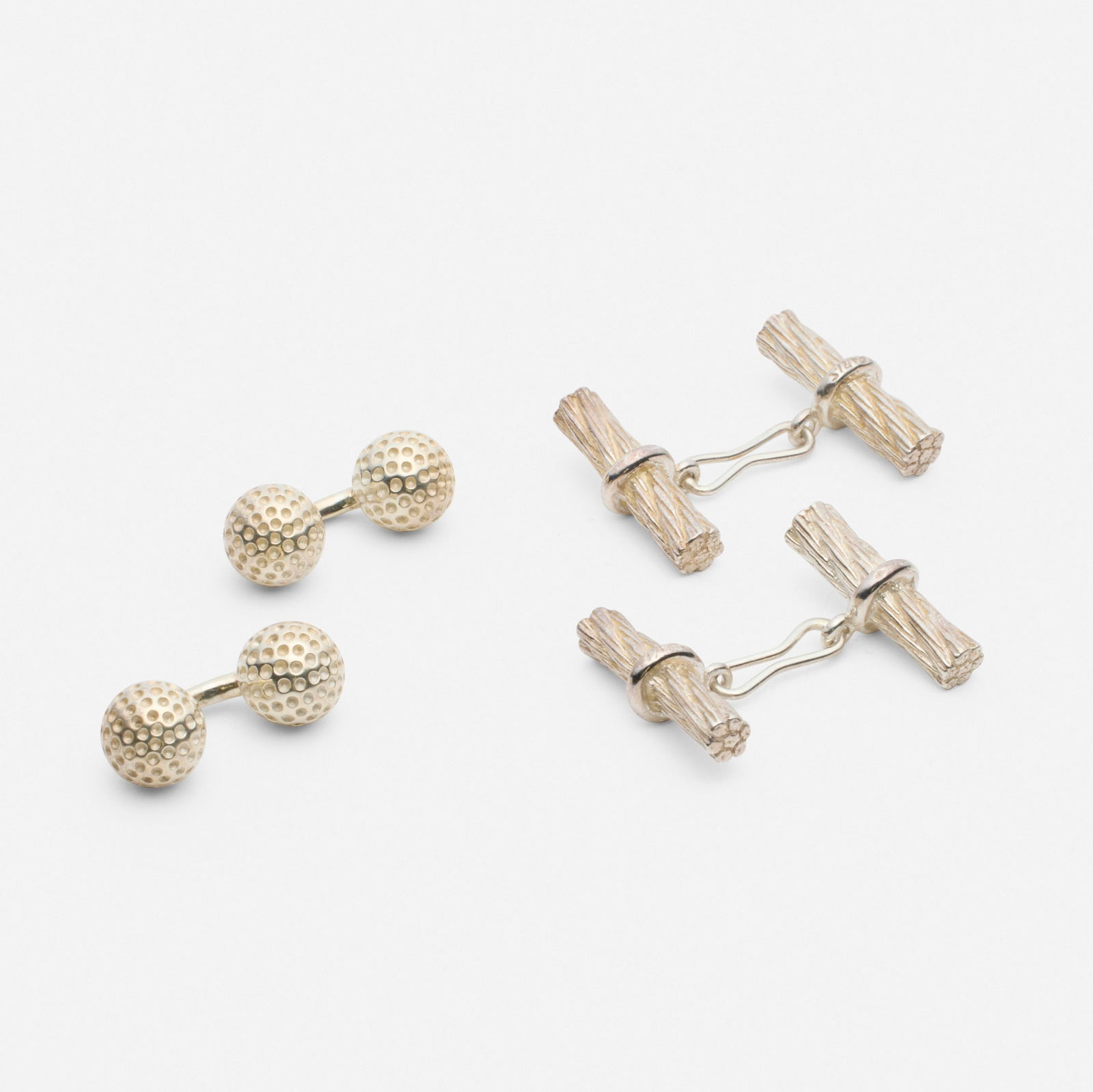 Hermes, Two pairs of silver cufflinks: Hermes Two pairs of silver cufflinks Comprising a pair of golf ball cufflinks; and pair of roped cufflinks Silver Signed Hermes to each example 0.875 x 0.375 in and 1.25 x 0.875 in; Gross weight