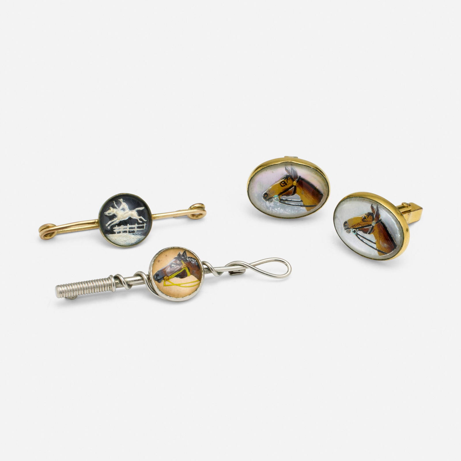 Group of Essex crystal jewelry: Group of Essex crystal jewelry Comprising two brooches and a pair of cufflinks, each set with an Essex crystal depicting a horse Gold-plate and base metal Brooches 2.25 x 0.50 in, 1.625 x 0.50 in, cuf