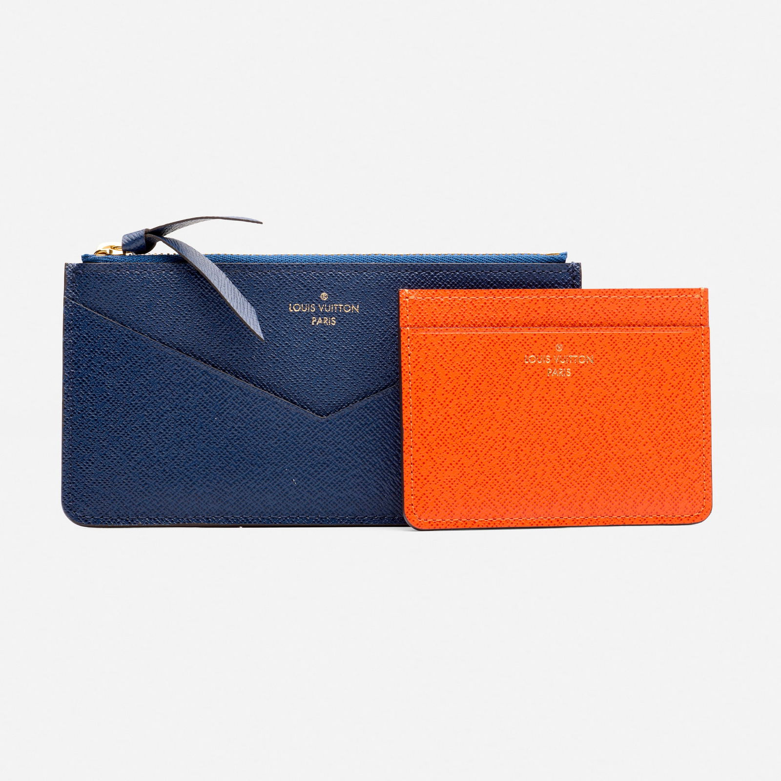 Louis Vuitton, 'Jeanne' wallet and card holder: Louis Vuitton 'Jeanne' wallet and card holder Navy and red Taiga leather Leather, metal Signed Louis Vuitton to each example 6.25 x 3.25 in and 3.75 x 2.75 in Sold with signed box, bag, and dust