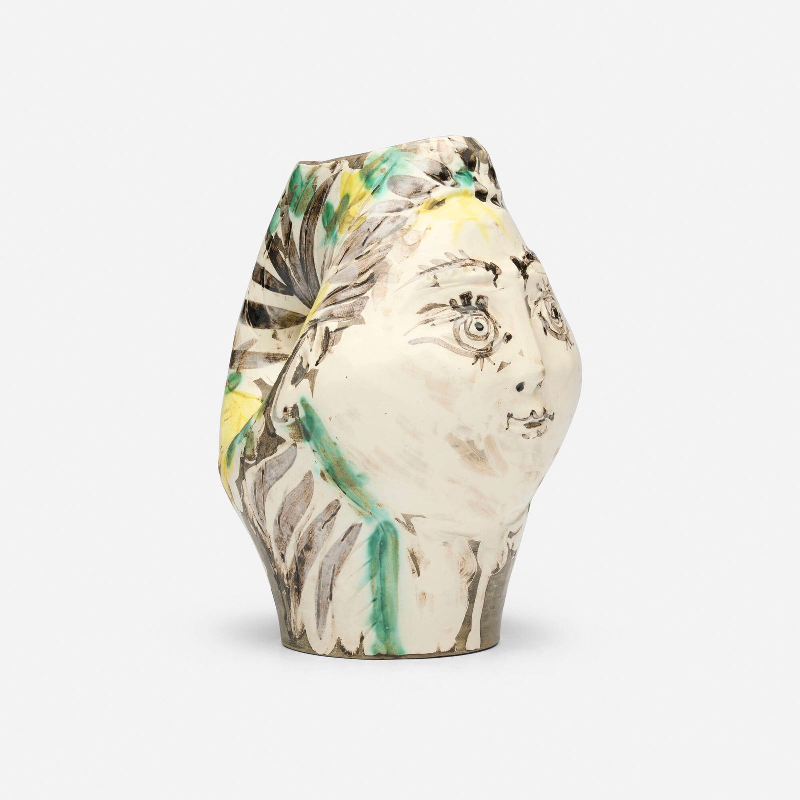 Pablo Picasso, Tete de femme couronnee de fleurs: Pablo Picasso Tete de femme couronnee de fleurs 1954white earthenware clay, decoration in engobes under partial brushed glaze 9 h x 6.25 w x 7 d in (23 x 16 x 18 cm) Incised studio mark and nu