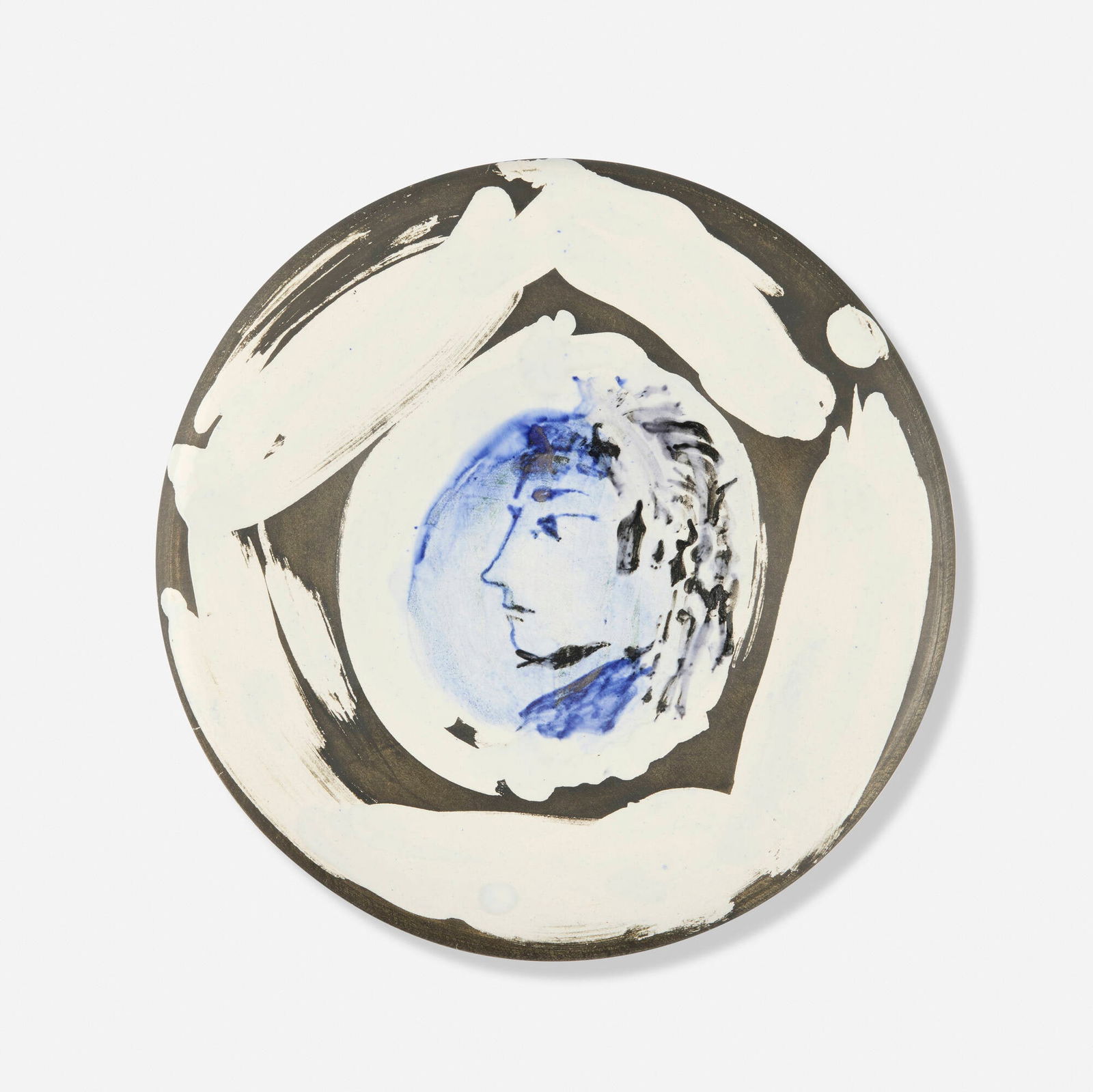 Pablo Picasso, Profil de femme no.67: Pablo Picasso Profil de femme no.67 1963white earthenware clay, decoration in engobes and under brushed glaze, black patina 1 d x 10 dia in (3 x 25 cm) Glazed signature and number to verso 'Ed