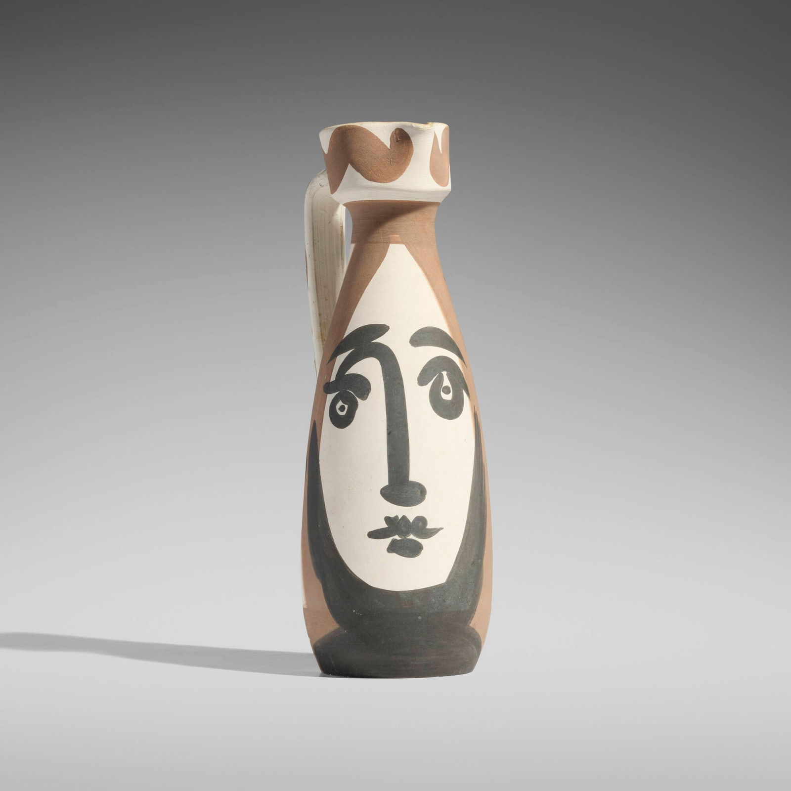 Pablo Picasso, Visage pitcher: Pablo Picasso Visage pitcher 1955white earthenware with engobe decoration 11.75 h x 5.5 w x 4 d in (30 x 14 x 10 cm) Glazed studio mark to underside 'Edition Picasso Madoura'. Impressed studio