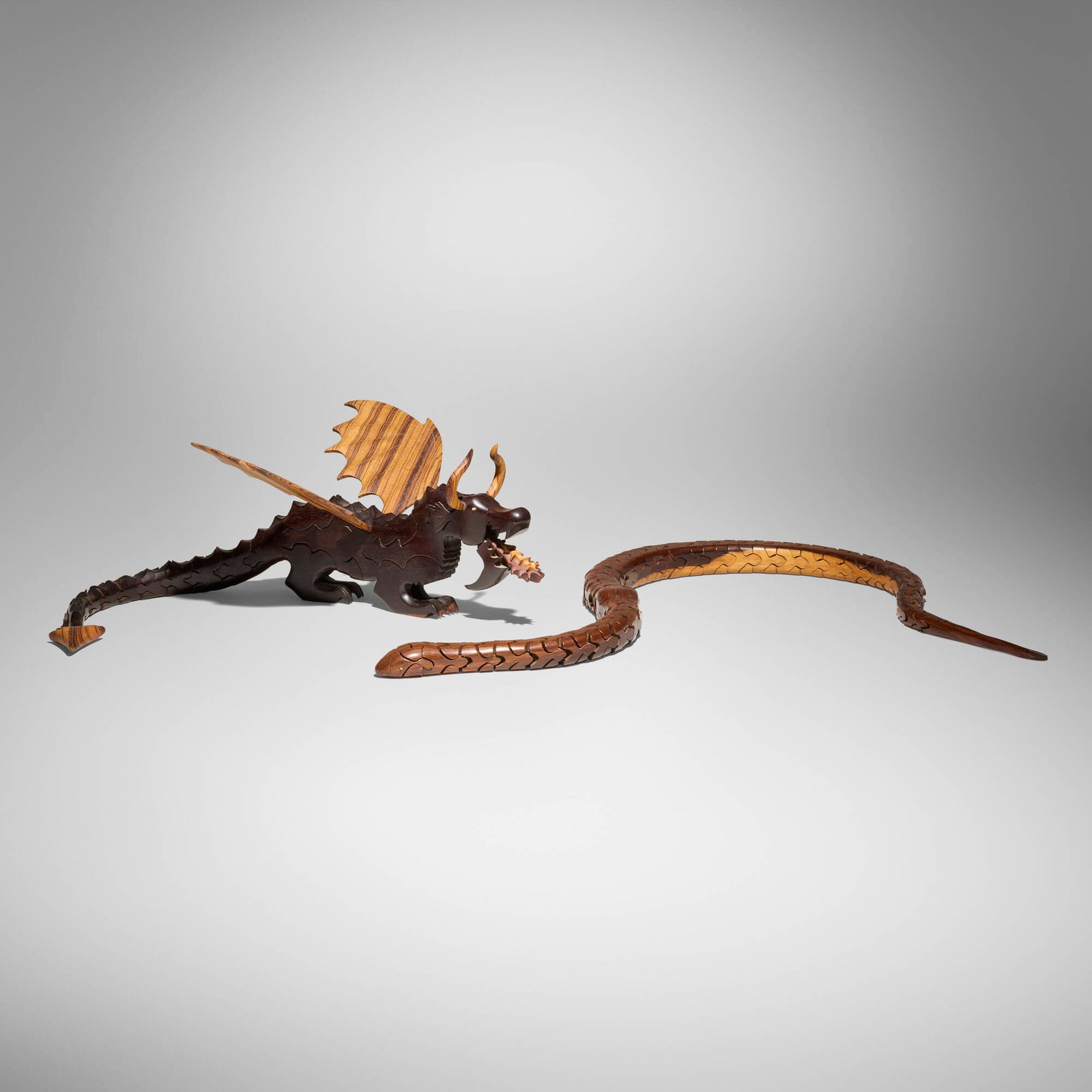 Peter and Genesis Chapman, Dragon #3; Snake (two works): Peter and Genesis Chapman Dragon #3; Snake (two works) USA, 1996cocobolo, zebra wood dragon: 9.125 h x 37 w x 15.75 d in (23 x 94 x 40 cm) snake: 1.75 h x 55 w x 2.25 d in (4 x 140 x 6 cm)