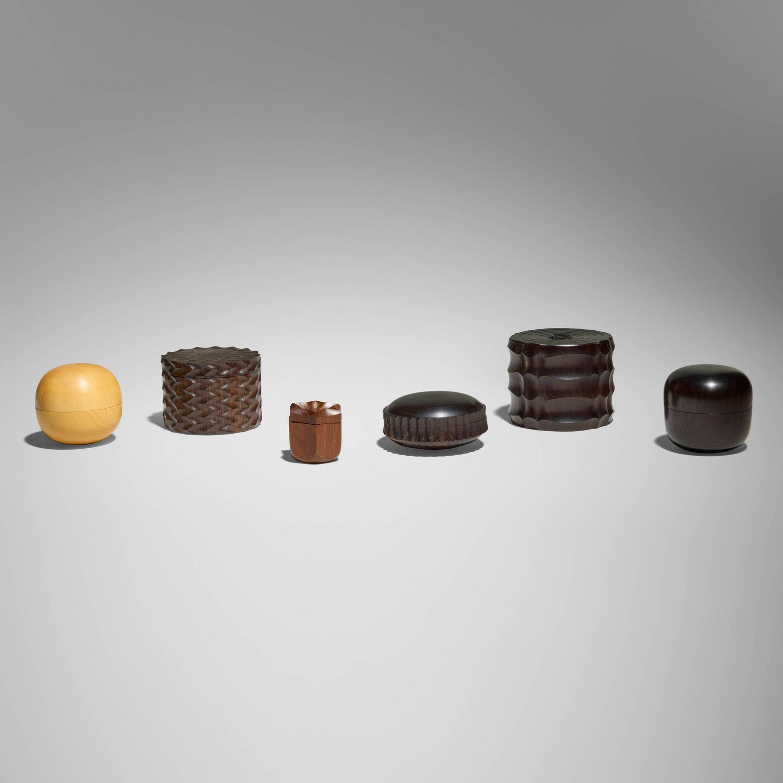 Dale Chase, Collection of six boxes: Dale Chase Collection of six boxes 1979-2005boxwood, pink ivory wood, holywood, African blackwood tallest: 2.5 h x 3.125 dia in (6 x 8 cm) shortest: 1.5 h x 2.875 dia in (4 x 7 cm) Proceeds