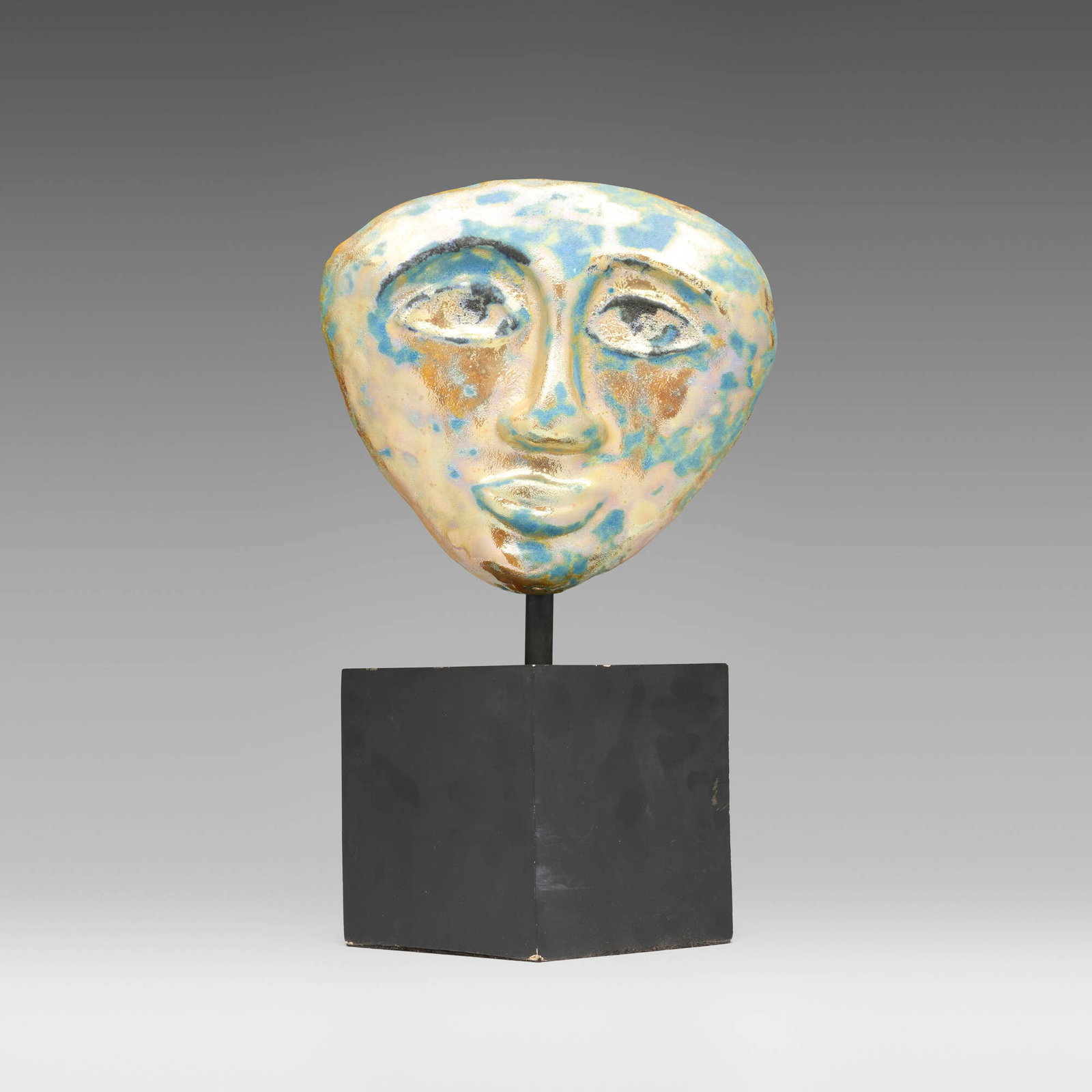 Beatrice Wood, Mask: Beatrice Wood Mask lustre-glazed earthenware base: 14.5 h x 6 w x 6 d in (37 x 15 x 15 cm) mask: 9.25 h x 10.25 w x 2 d in (23 x 26 x 5 cm) Glazed signature to reverse 'Beato'. Provenance: