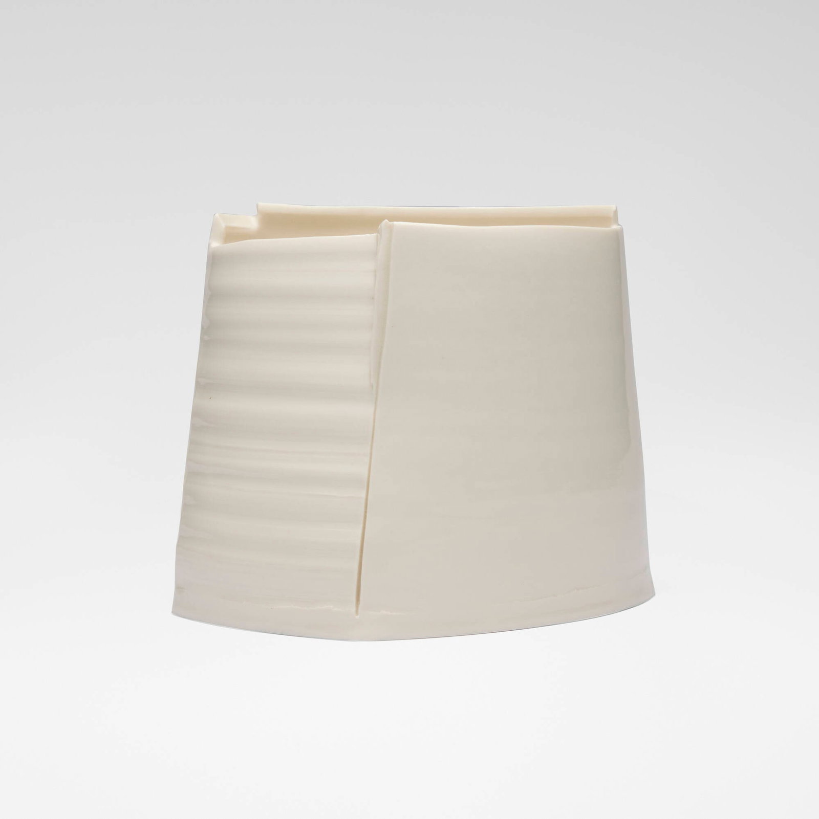 Carina Ciscato, White Asymmetric Pot: Carina Ciscato White Asymmetric Pot c. 2009 glazed porcelain 5.875 h x 7.25 w x 5.625 d in (15 x 18 x 14 cm) Provenance: Joanna Bird Pottery, London | Acquired from the previous in 2009,