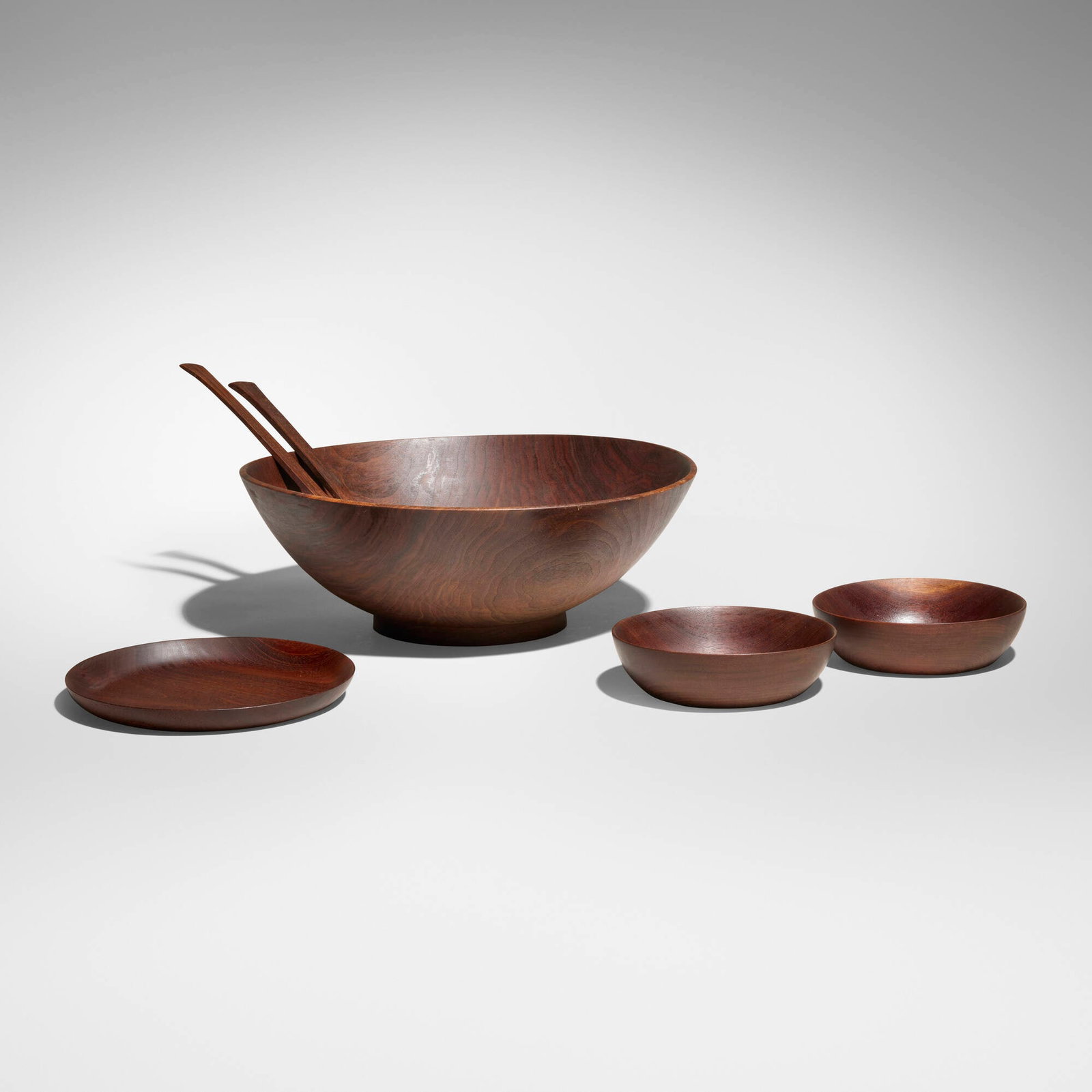 Bob Stocksdale, Six-piece salad set: Bob Stocksdale Six-piece salad set 1981black walnut, mahogany serving bowl (tallest): 5 h x 13.75 dia in (13 x 35 cm) plate (shortest): 1 h x 5 dia in (3 x 13 cm) Set is comprised of one la