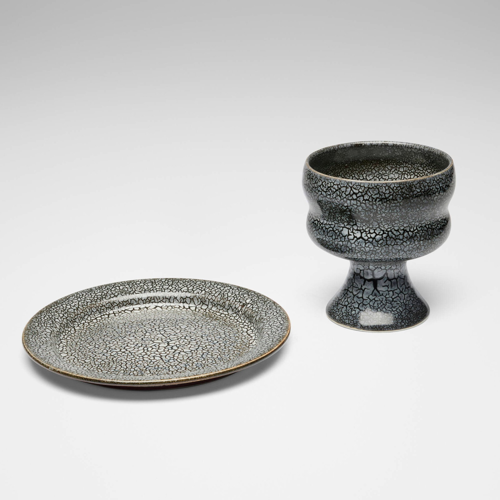 Brother Thomas Bezanson, Chalice and plate: Brother Thomas Bezanson Chalice and plate after 1985kairagi-glazed porcelain 6 h x 5.5 dia in (15 x 14 cm) 0.75 h x 9.625 dia in (2 x 24 cm) Incised ichthys symbol to underside of chalice.