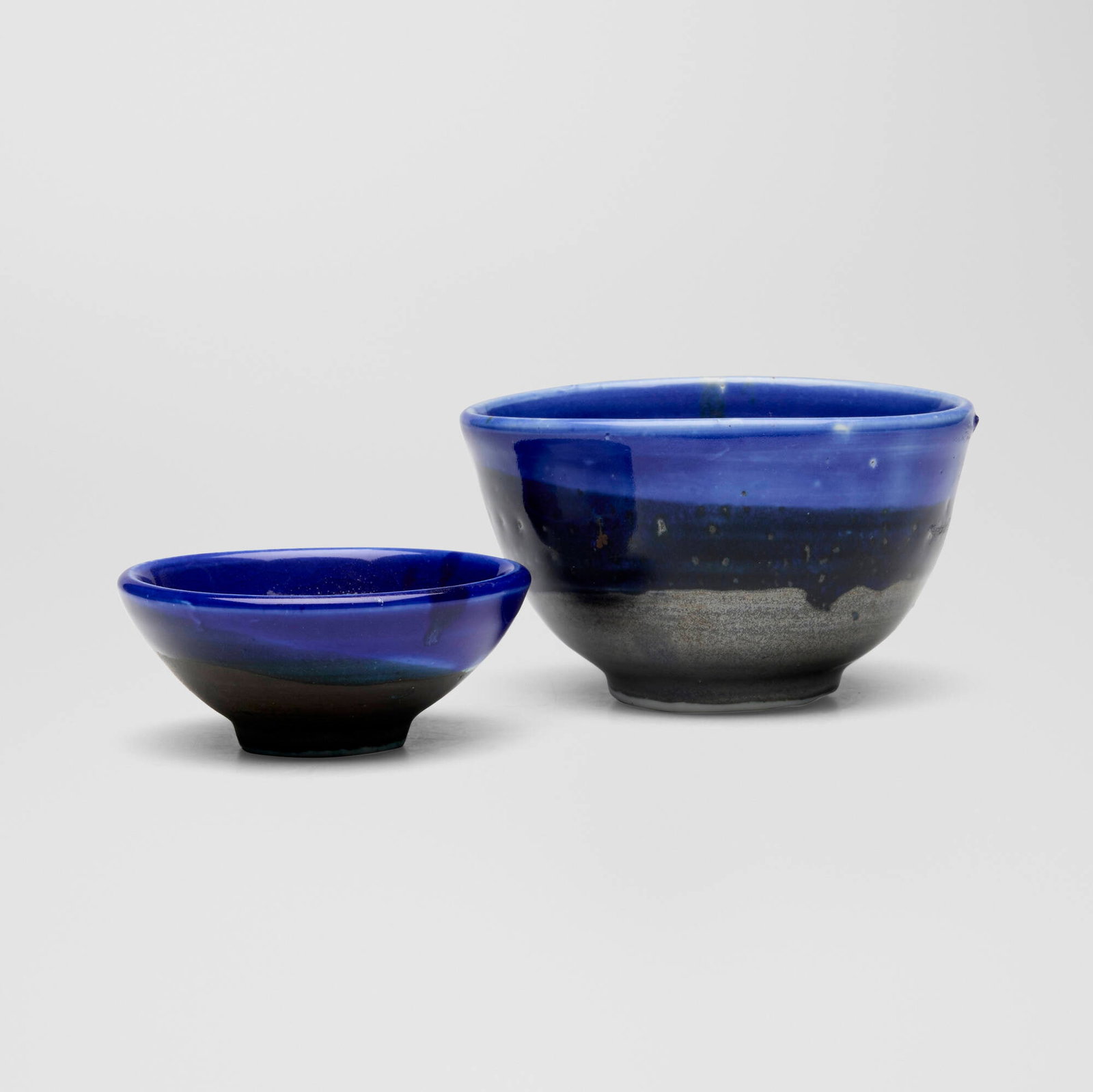 Toshiko Takaezu, Tea bowls (two works): Toshiko Takaezu Tea bowls (two works) c. 2005 Glass Blue-glazed porcelain 2.5 h x 4.5 w x 4.125 d in (6 x 11 x 10 cm) 1.375 h x 3.5 dia in (3 x 9 cm) Incised signature to underside of each example