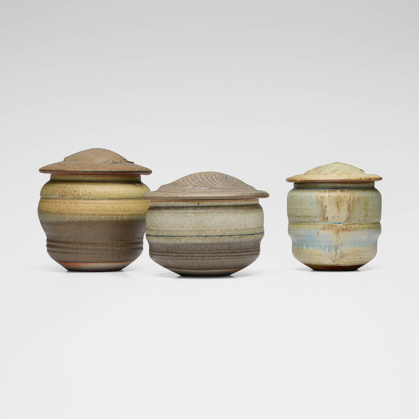 Karen Karnes, Collection of three covered vessels: Karen Karnes Collection of three covered vessels 1990glazed stoneware 7 h x 6.75 dia in (18 x 17 cm) 6.25 h x 5.5 dia in (16 x 14 cm) 5.75 h x 7.125 dia in (15 x 18 cm) Impressed artist'