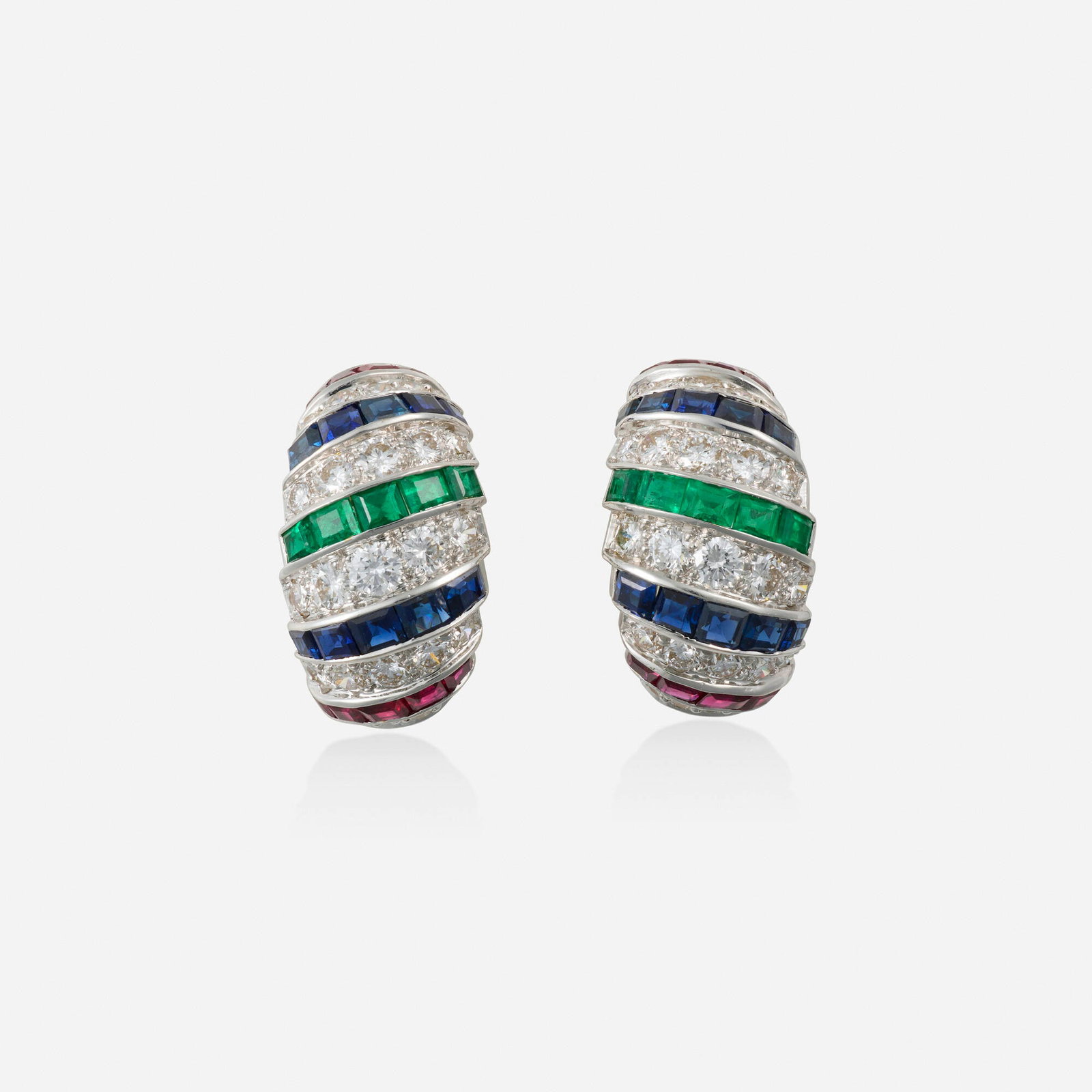 Multi-gem, diamond, and gold earrings: Multi-gem, diamond, and gold earrings Set with alternating rows of square-cut rubies, sapphires, emeralds and round brilliant-cut diamonds; 1992 18k plated-white gold 0.75 x 0.50 in; Gross weight 9.0 