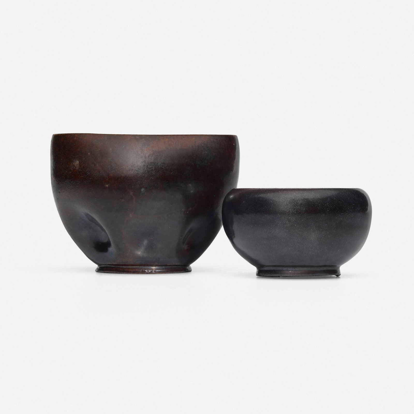 George E. Ohr, Vases, set of two: George E. Ohr Vases, set of two USA, 1897-1900 glazed earthenware 3.25 h x 4.375 w x 3.75 d in (8 x 11 x 10 cm) 2 h x 3.25 dia in (5 x 8 cm) Larger example features a dimpled body and brown glaze.
