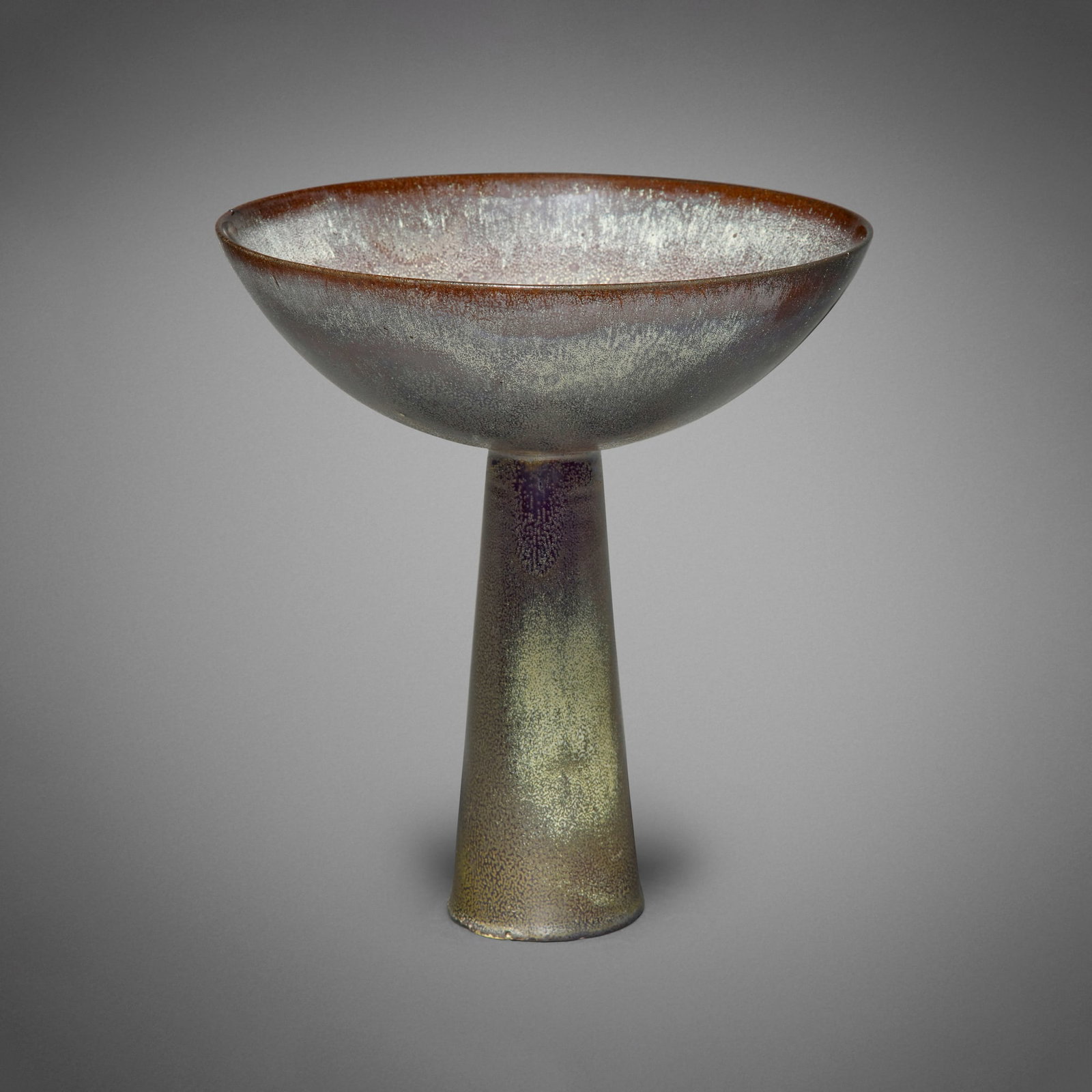 Gertrud and Otto Natzler, Bowl on tall conical base: Gertrud and Otto Natzler Bowl on tall conical base 1971 earthenware with Cat's Eye Reduction Fired glaze with ash deposits 10.25 h x 9.25 dia in (26 x 23 cm) Signed to underside 'Natzler' with