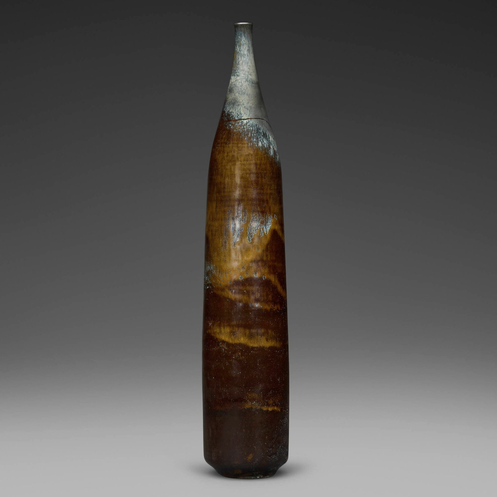 Gertrud and Otto Natzler, Tall cylindrical bottle: Gertrud and Otto Natzler Tall cylindrical bottle 1968 earthenware with Dark Cat's Eye Reduction Fired glaze with melt fissures 16 h x 3 dia in (41 x 8 cm) Signed to underside 'Natzler' with archive