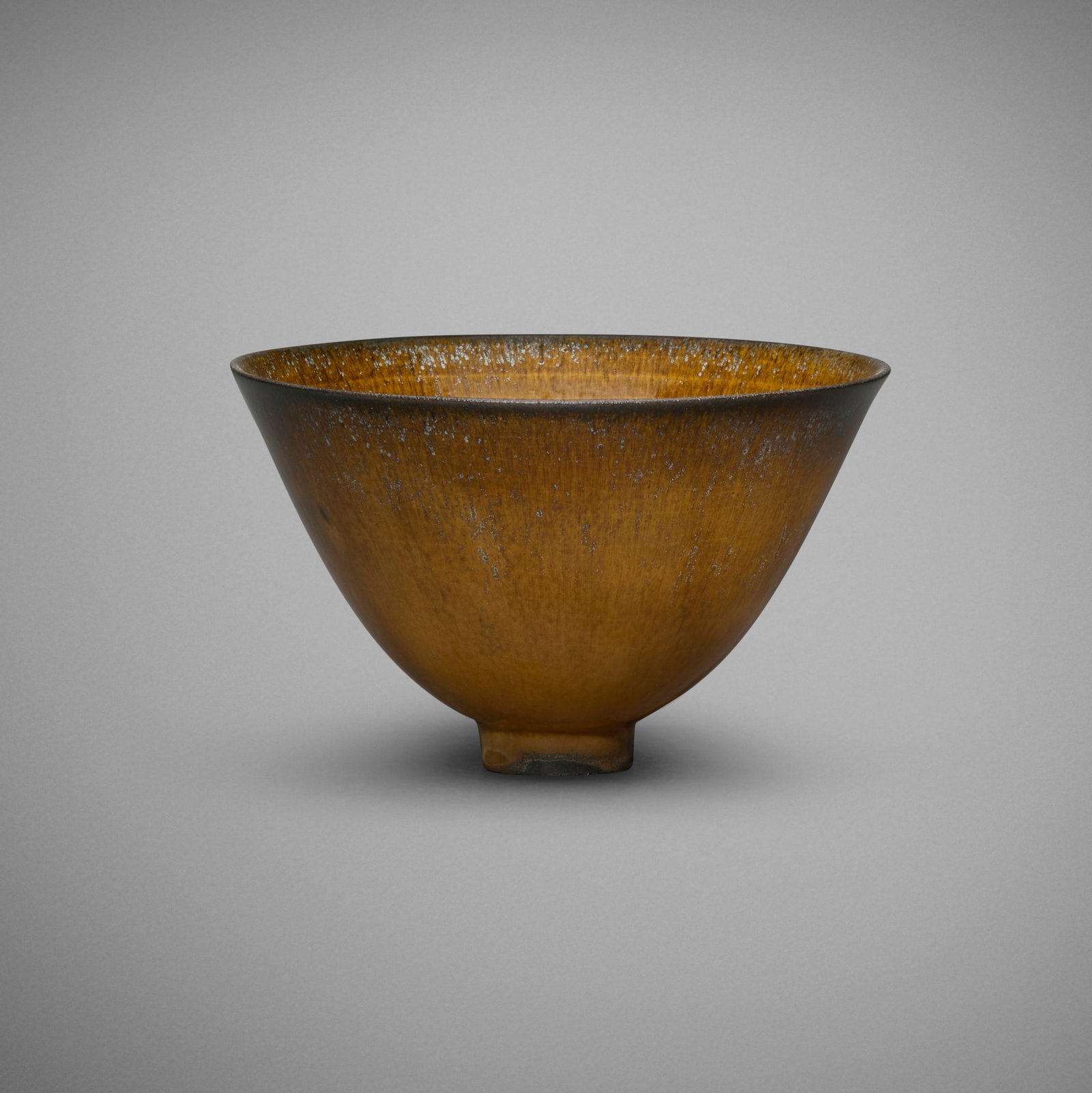 Gertrud and Otto Natzler, Flaring bowl: Gertrud and Otto Natzler Flaring bowl 1963 earthenware with Tiger Eye Reduction Fired glaze 4 h x 6.5 dia in (10 x 17 cm) Signed to underside 'Natzler' with archive number 'M634' and