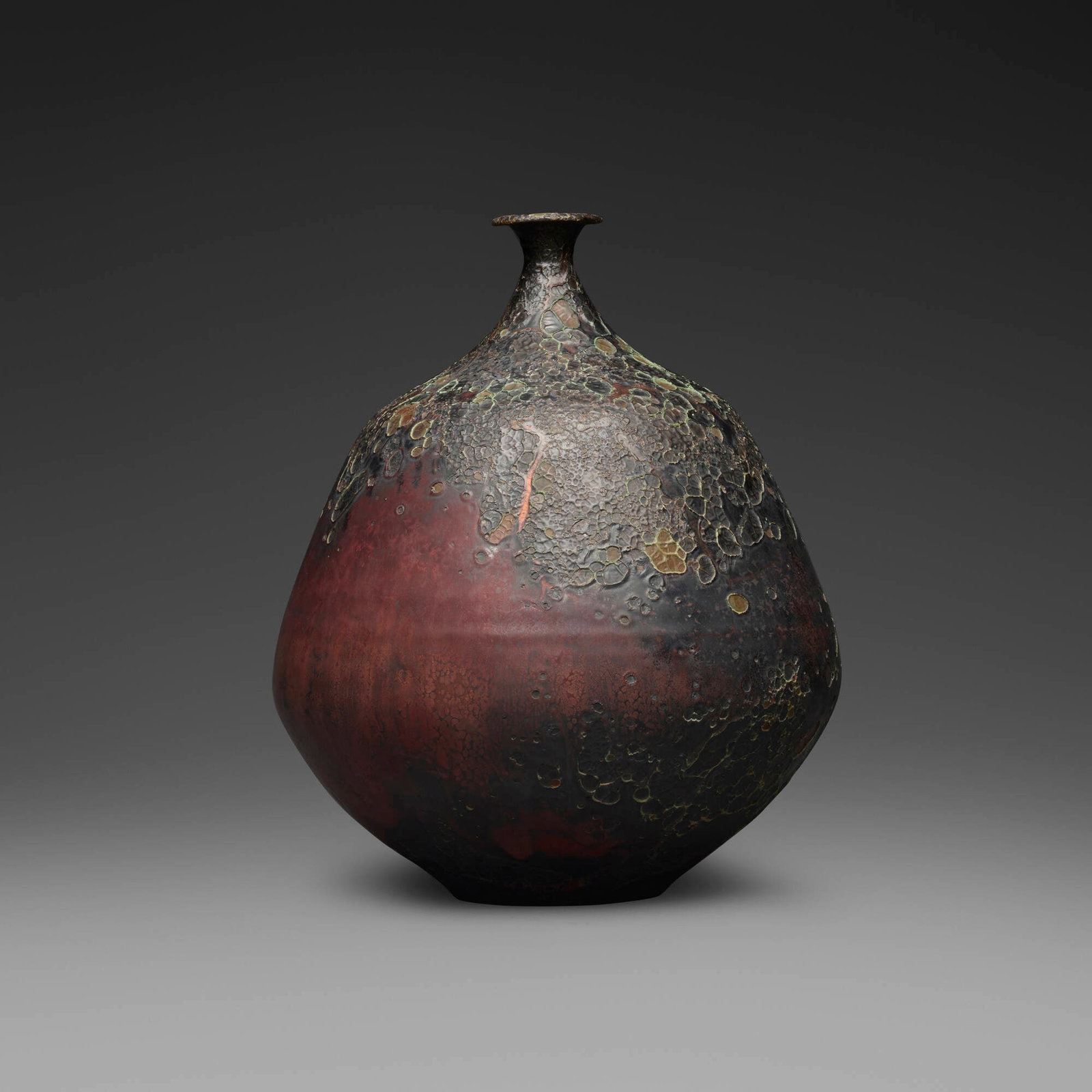 Gertrud and Otto Natzler, Bottle form with curved neck and lip: Gertrud and Otto Natzler Bottle form with curved neck and lip 1973 earthenware with Sang Reduction Fired glaze with flame marks, iridescence, and copper pools 9.75 h x 8 dia in (25 x 20 cm) Signed to