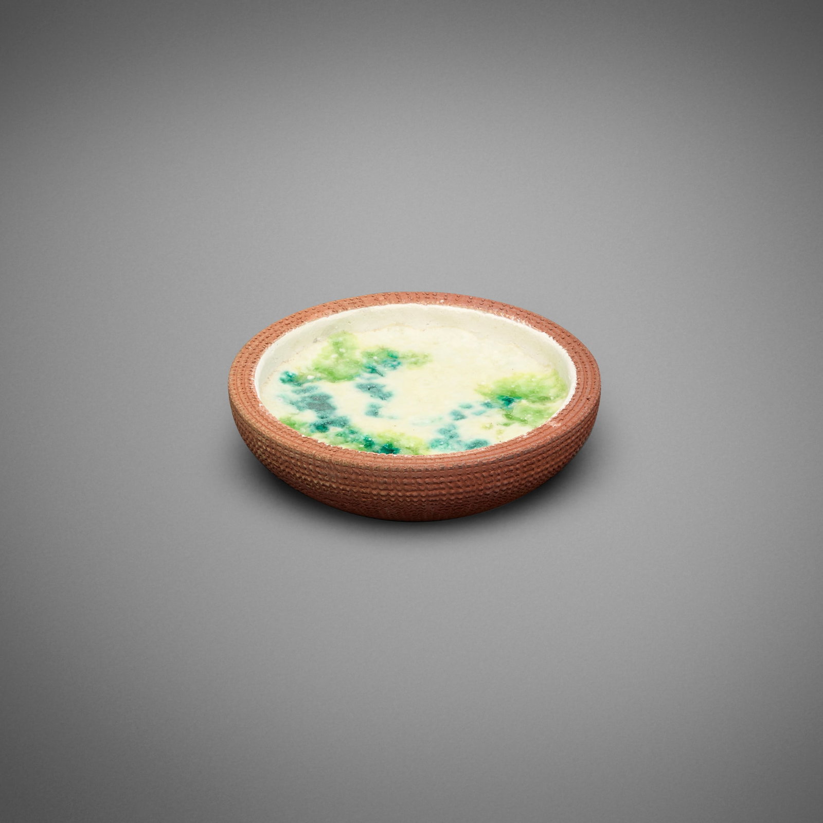 Gertrud and Otto Natzler, Massive tray: Gertrud and Otto Natzler Massive tray earthenware with White, Green and Turquoise glaze 1.25 h x 5 dia in (3 x 13 cm) Massive refers to the thick walls, rather than the size, of the present work.