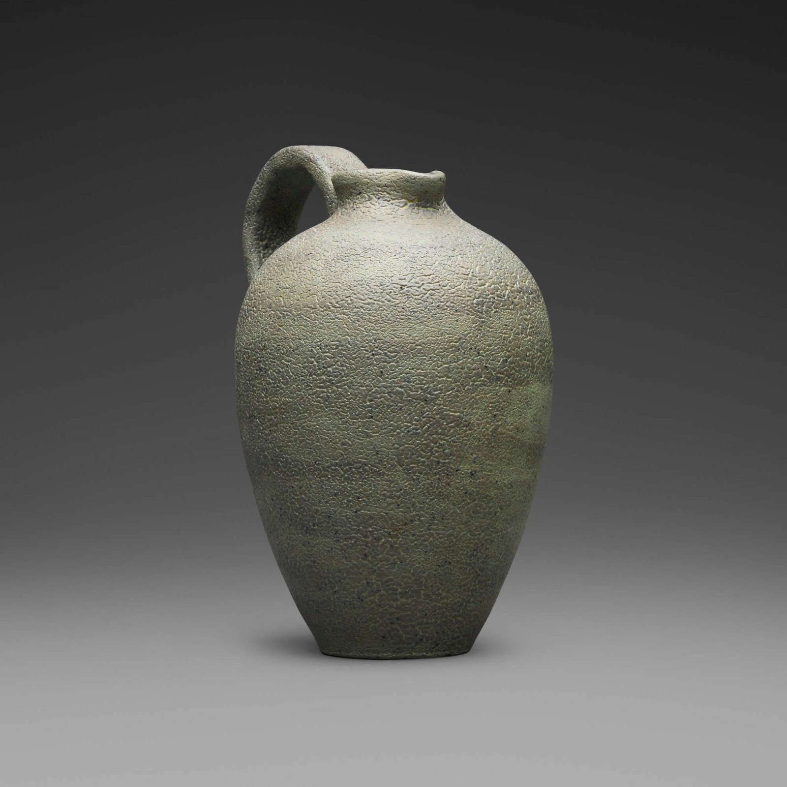 Gertrud and Otto Natzler, Rounded pitcher with handle: Gertrud and Otto Natzler Rounded pitcher with handle 1939 earthenware with Silvergreen Textured glaze 6.25 h x 4.75 w x 3.75 d in (16 x 12 x 10 cm) Incised monogram to underside 'GON' with arch