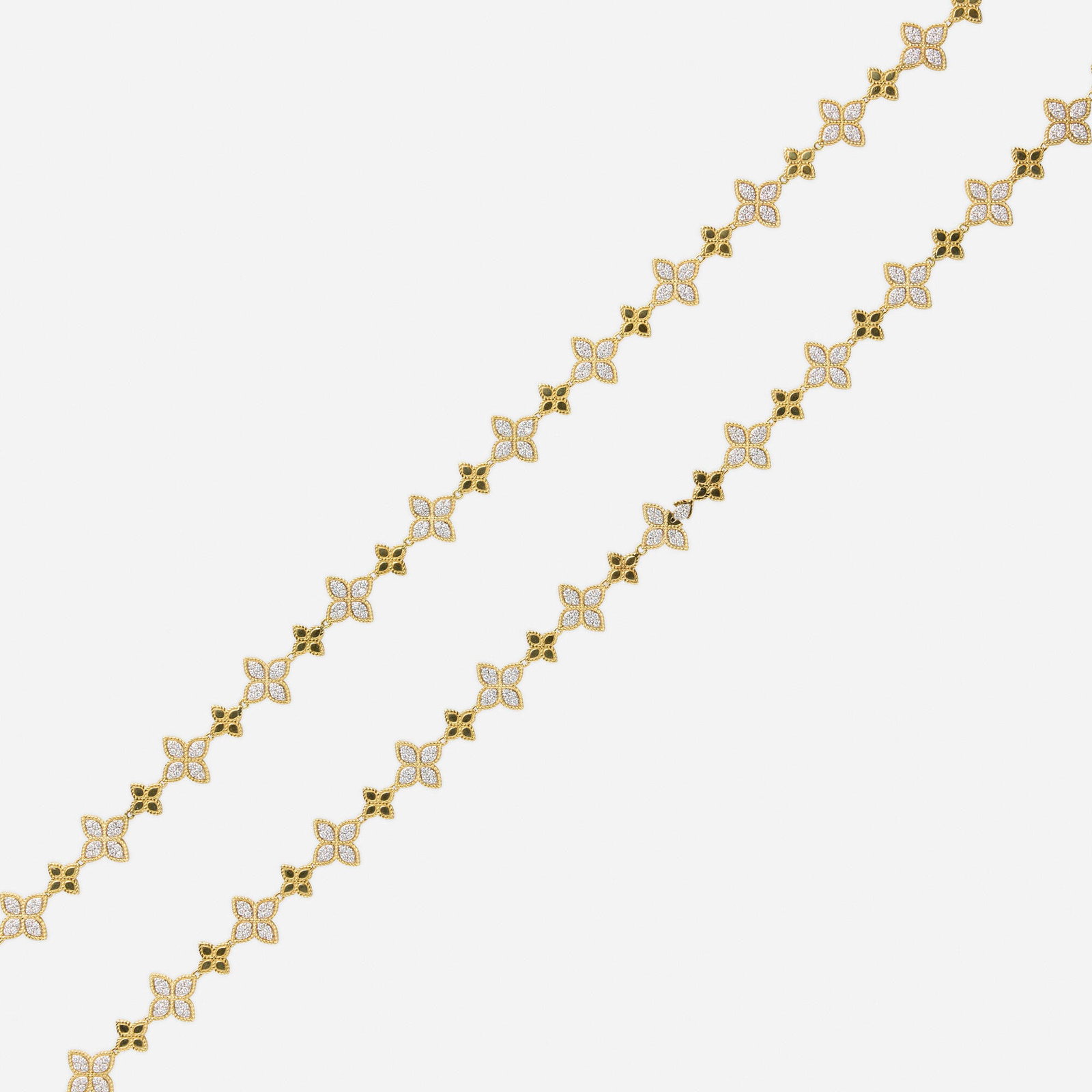Roberto Coin, Diamond and bicolor gold necklace: Roberto Coin Diamond and bicolor gold necklace Designed with quatrefoil links set with round brilliant-cut diamonds 18k yellow and white gold Signed RC 33 in; Gross weight 46.4 dwts