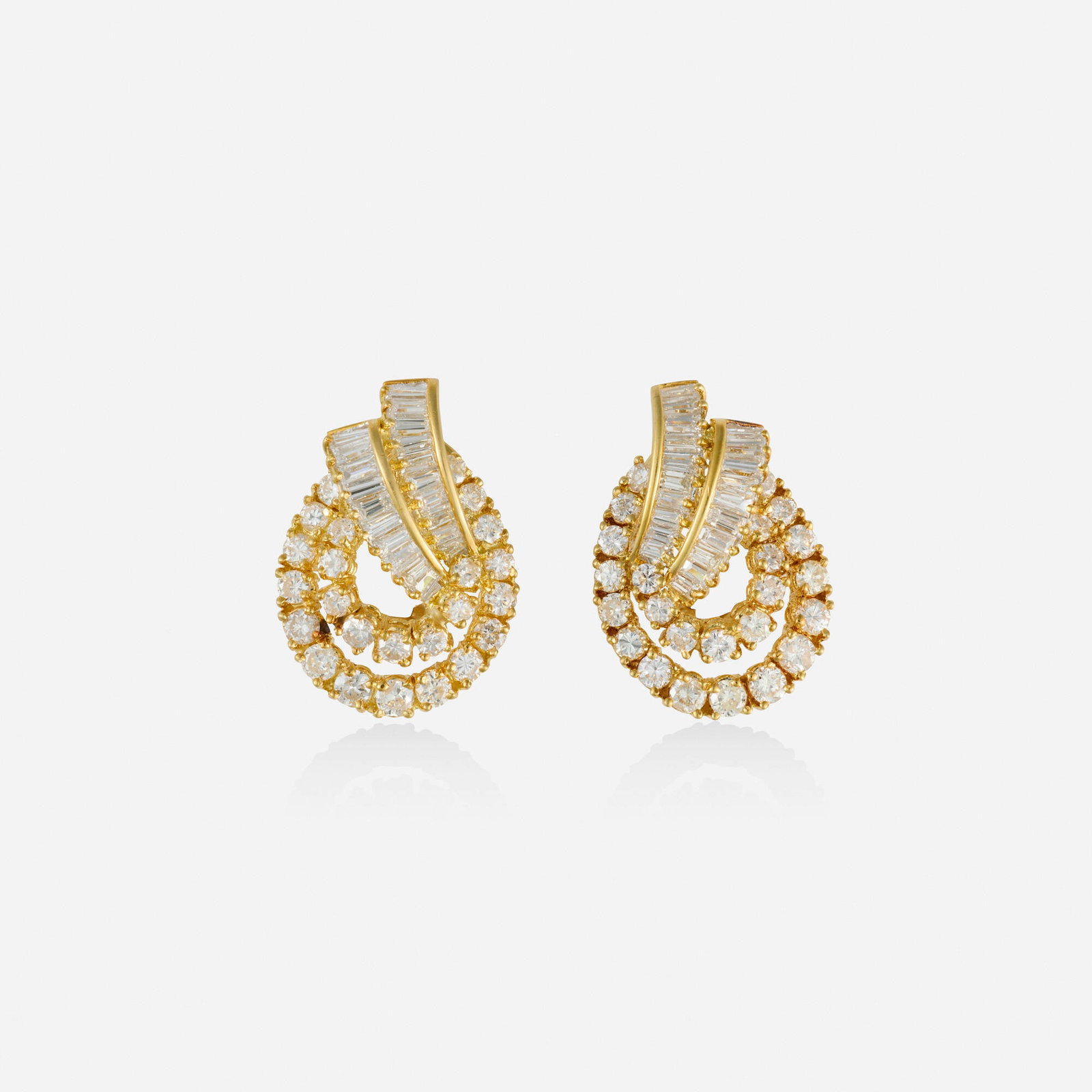 Diamond and gold earrings: Diamond and gold earrings Each set with round brilliant and baguette-cut diamonds 18k yellow gold 1 x 0.625 in; Gross weight 7.5 dwts Provenance: Private New York City Collection This