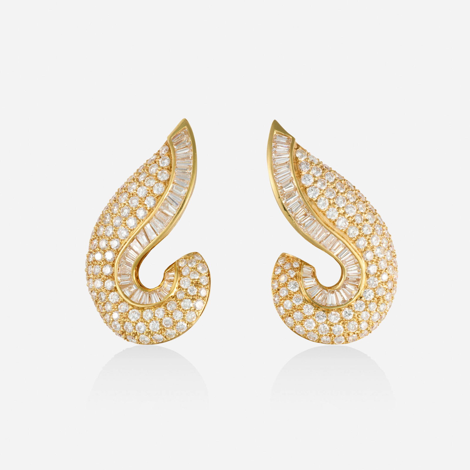 Adler, Diamond and gold earrings: Adler Diamond and gold earrings Each set with round brilliant and tapered baguette-cut diamonds 18k yellow gold Signed Alder 1.50 x 0.875 in; Gross weight 11.5 dwts This work will ship from