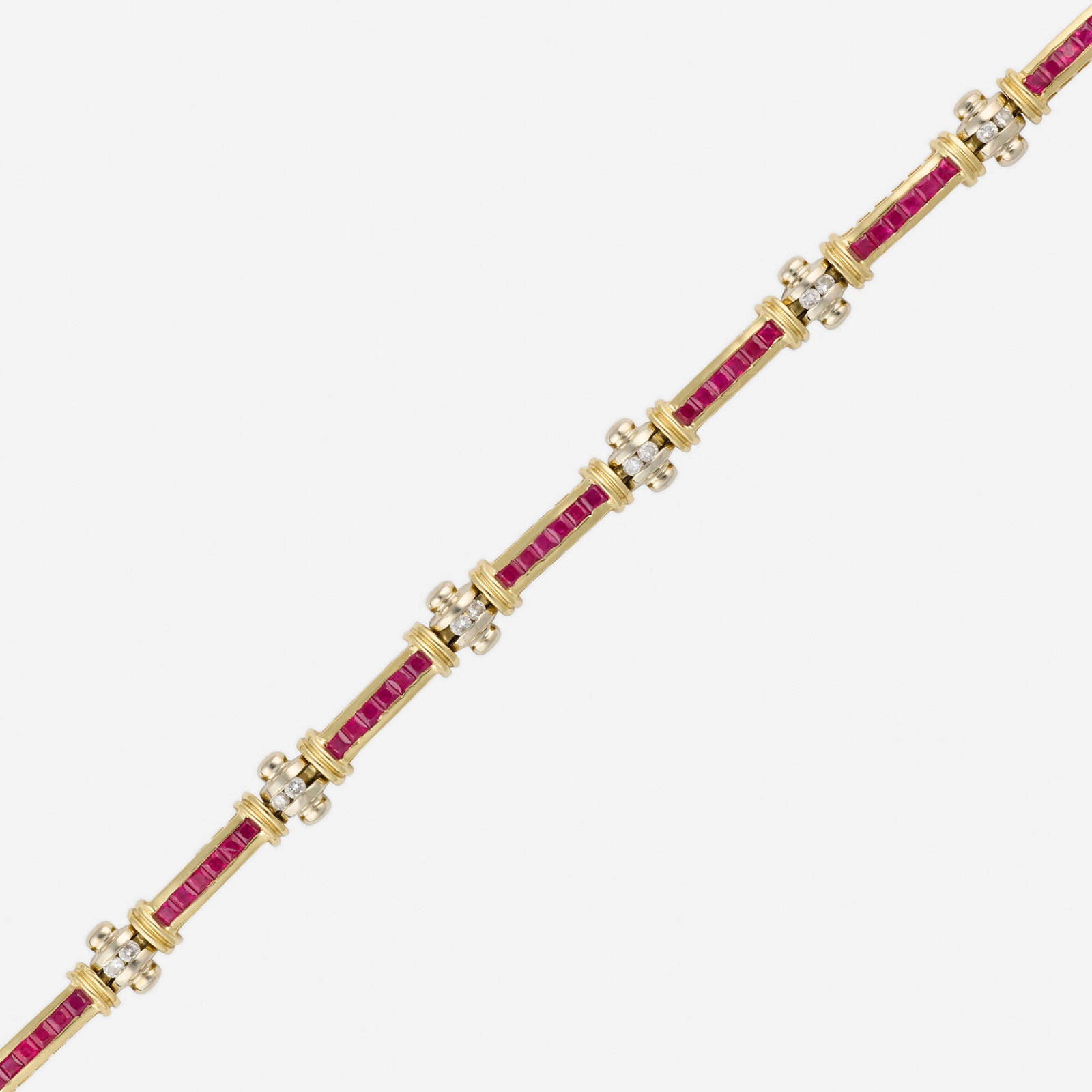 Ruby, diamond, and bicolor gold bracelet: Ruby, diamond, and bicolor gold bracelet Channel-set with square-cut rubies and round brilliant-cut diamonds 14k yellow and white gold 7 x 0.25 in; Gross weight 13.9 dwts This work will ship from