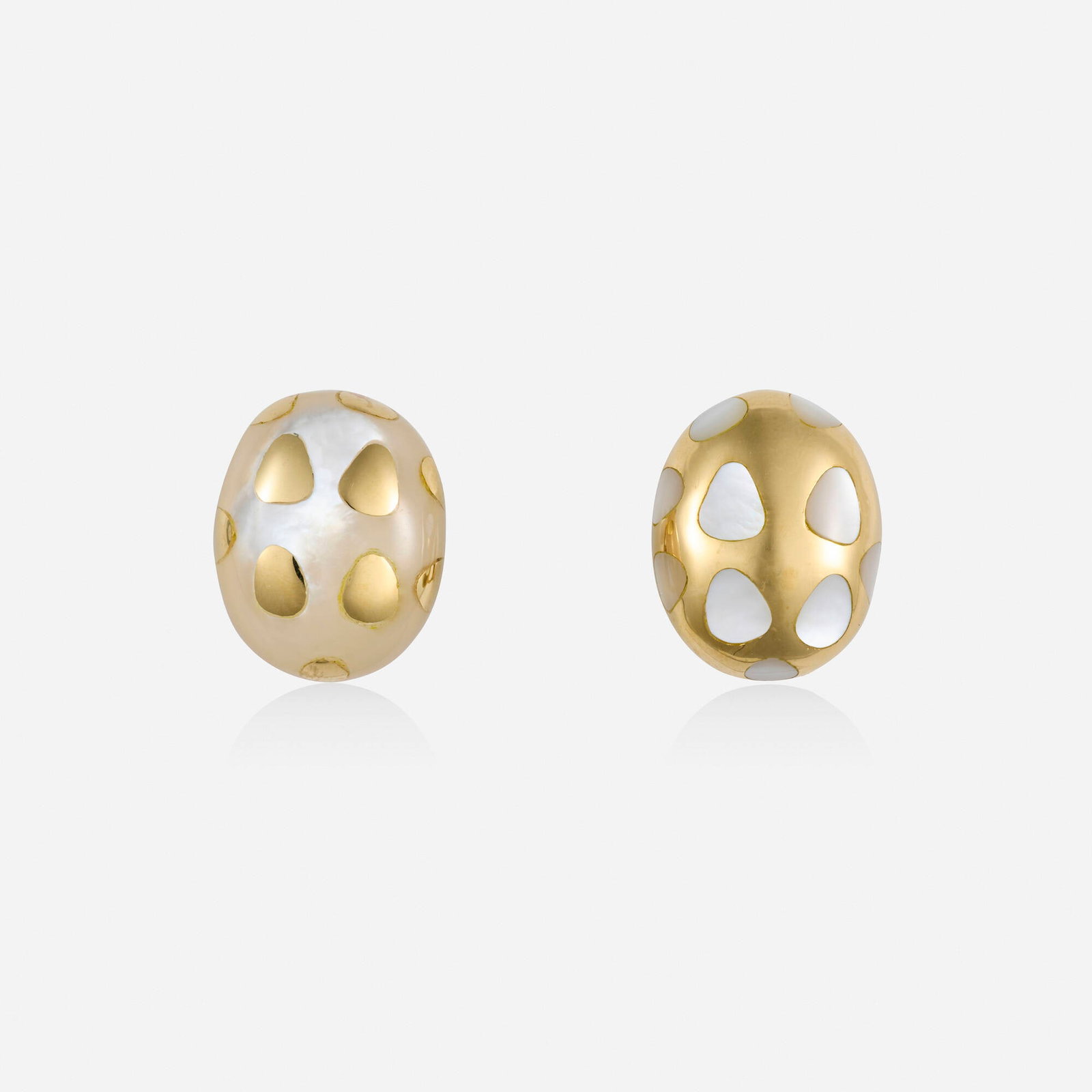 Mother-of-pearl and gold earrings: Mother-of-pearl and gold earrings One of carved mother-of-pearl, inlaid with gold dots; the other of gold, inlaid with mother-of-pearl dots 18k yellow gold 0.75 x 0.625 in; Gross weight 10.5 dwts This