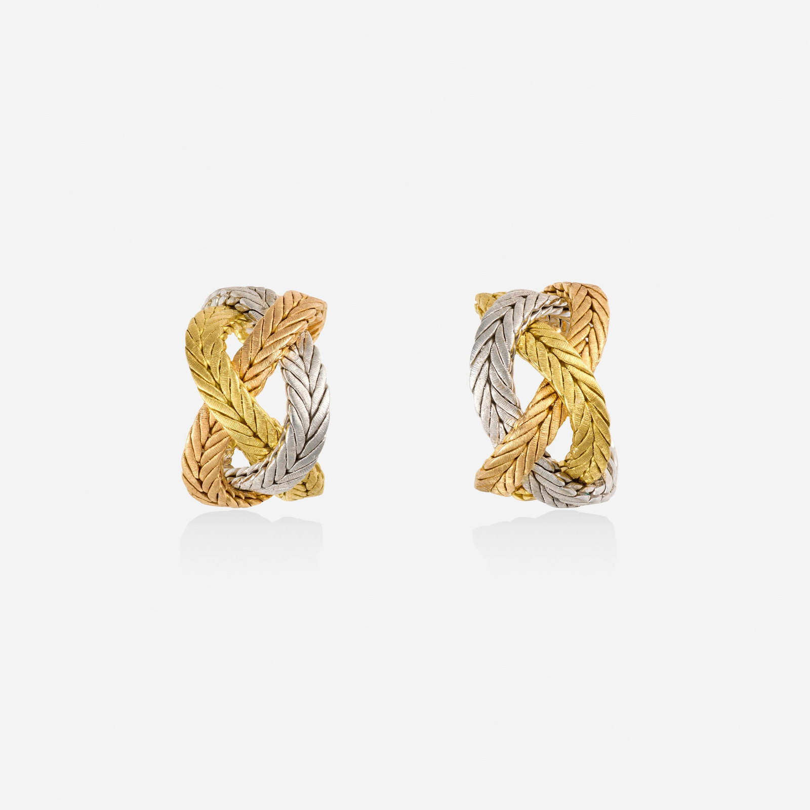 Buccellati, Tricolor gold earrings: Buccellati Tricolor gold earrings Of braided design 18k yellow, white, and pink gold Signed Buccellati 0.75 x 0.50 in; Gross weight 15.6 dwts This work will ship from Lambertvi