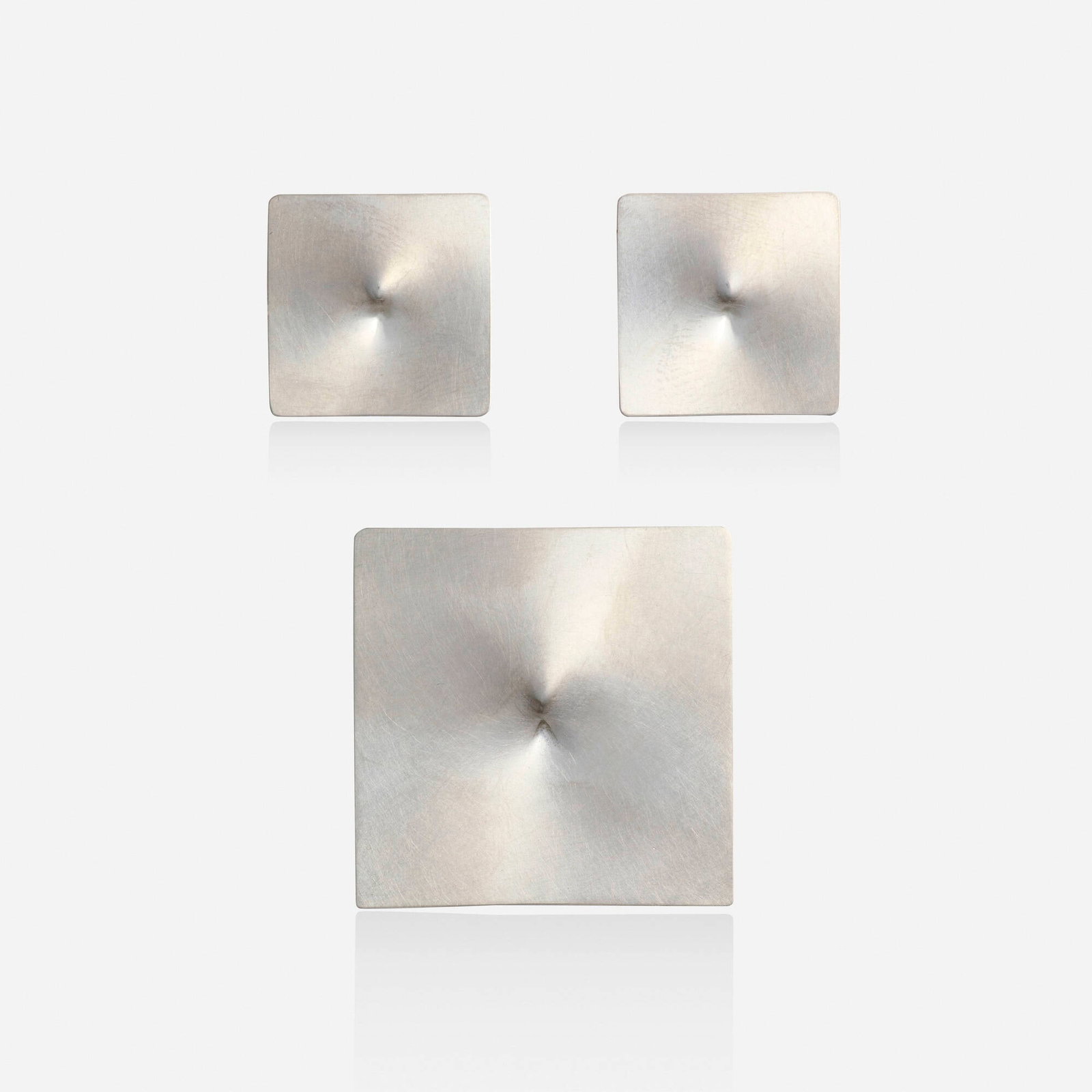 Niessing, 'Pythagoras' platinum earrings and brooch: Niessing 'Pythagoras' platinum earrings and brooch Each of square outline with concave center Platinum Signed Niessing to each example Brooch 1.50 x 1.50 in, earrings 0.875 x 0.875 in; Gross weight