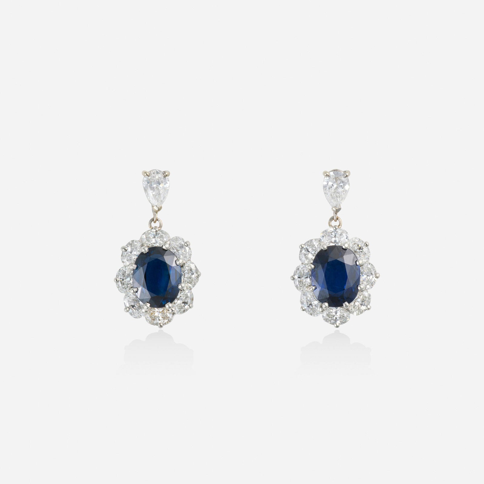 Oscar Heyman & Brothers, Sapphire, diamond, and platinum earrings: Oscar Heyman & Brothers Sapphire, diamond, and platinum earrings Each set with an oval-cut sapphire and pear and oval-cut diamonds Platinum Signed with maker's mark for Oscar Heyman & Brothers,