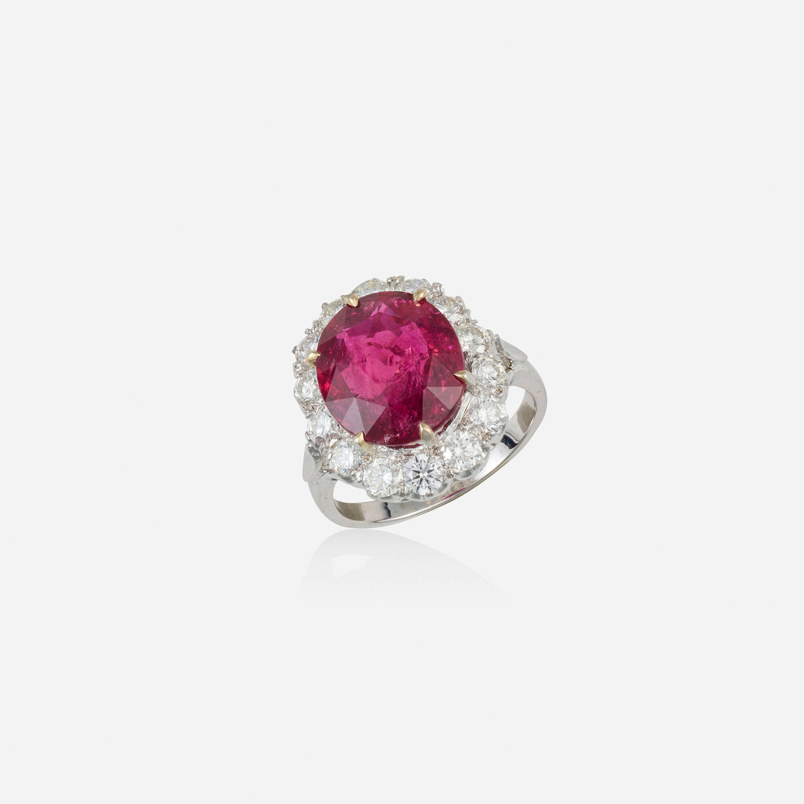 Rubellite, diamond, and white gold ring: Rubellite, diamond, and white gold ring Set with an oval-cut rubellite framed by round brilliant-cut diamonds 18k white gold Ring size 6.75; Gross weight 3.9 dwts This work will ship from