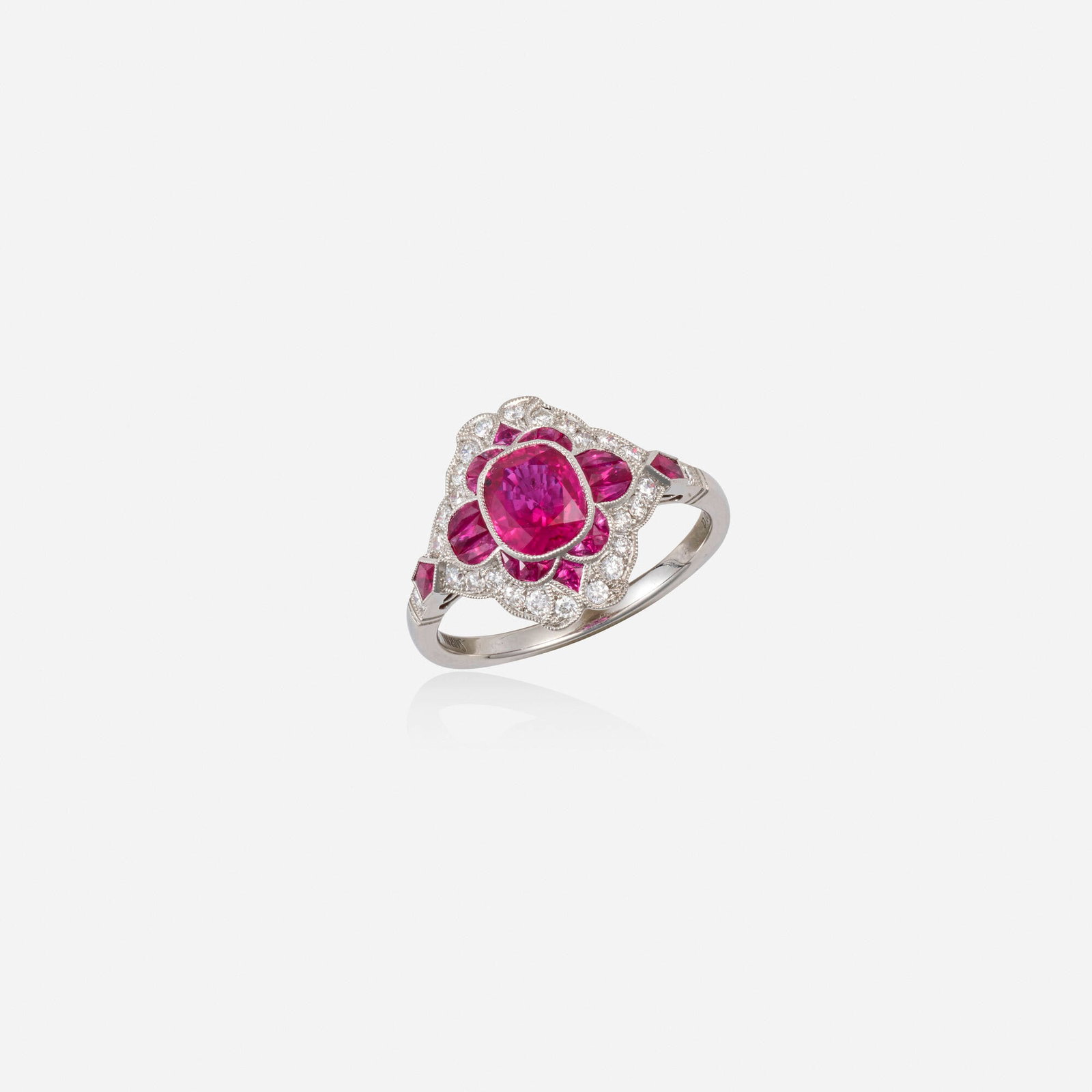 Ruby, diamond, and platinum ring: Ruby, diamond, and platinum ring Set with an oval and calibre-cut rubies and round brilliant-cut diamonds Platinum Ring size 6.50; Gross weight 2.8 dwts This work will ship from Lambertville, New Jers