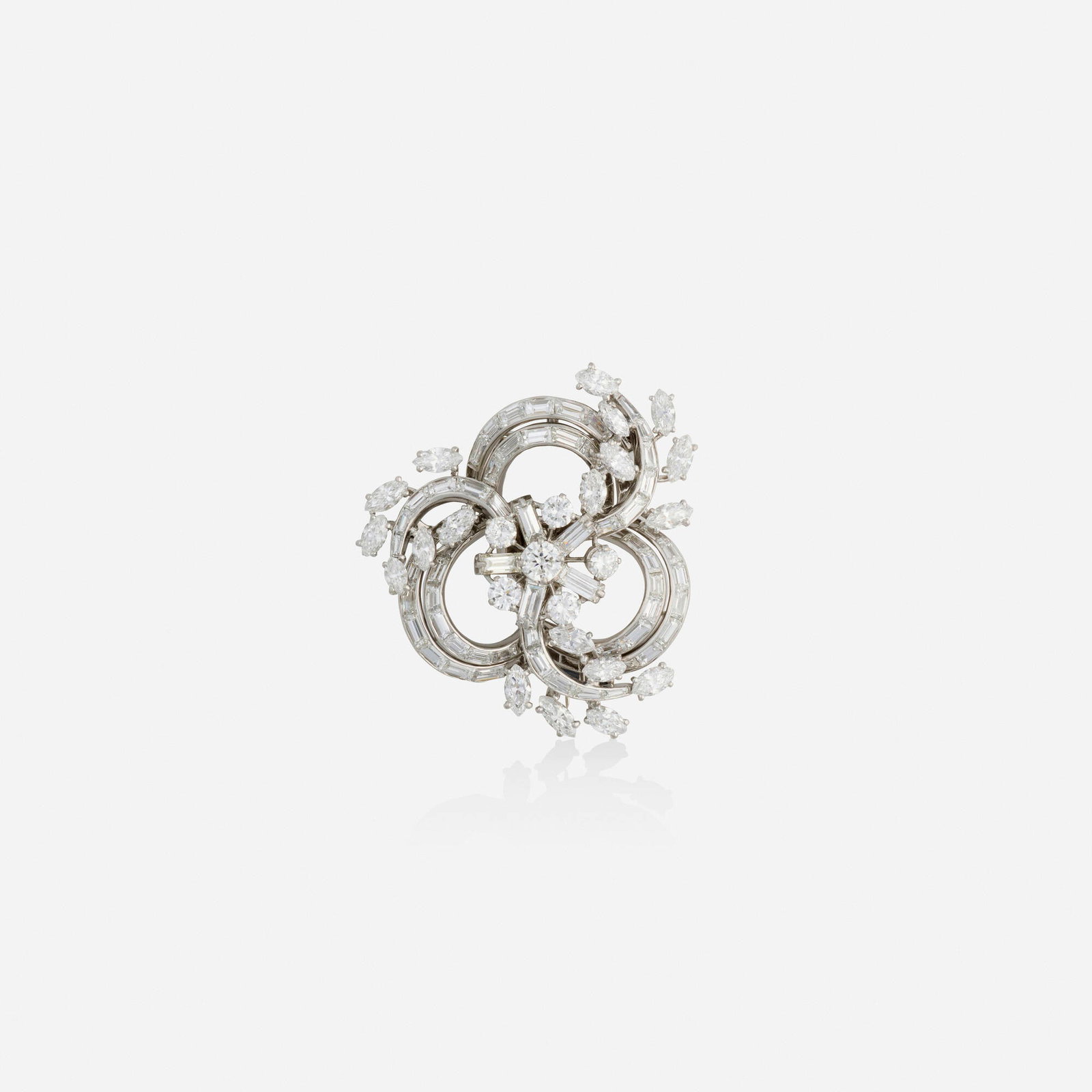French, Diamond and white gold brooch: French Diamond and white gold brooch Of scrolling design, set with marquise, baguette, and round brilliant-cut diamonds 18k white gold 1.375 x 1.375 in; Gross weight 12.2 dwts This work wi