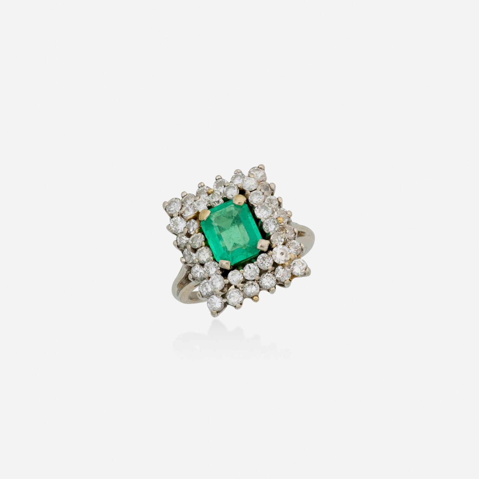 Emerald, diamond, and white gold ring: Emerald, diamond, and white gold ring Set with an emerald-cut emerald, framed by round brilliant-cut diamonds White gold Ring size 6; Gross weight 3.9 dwts This work will ship from Lambertville, New