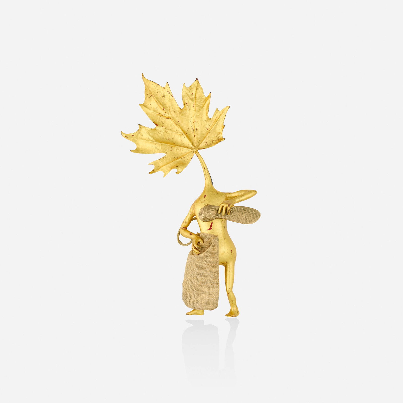 Bruce Metcalf, 'Figure Pin' brooch: Bruce Metcalf 'Figure Pin' brooch Of whimsical design; 1997 Gold leaf, wood, paint, burlap, cord, brass, base metal Signed Metcalf 4.875 x 2.50 in; Gross weight 19.0 dwts Provenance: Collection of