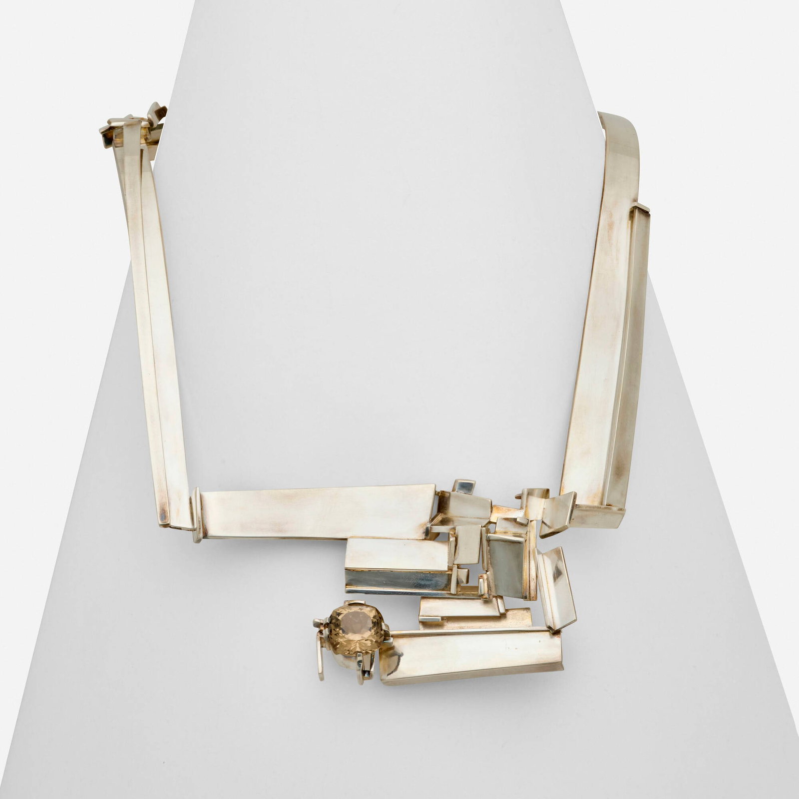 Helen Shirk, Sterling silver and smoky quartz necklace: Helen Shirk Sterling silver and smoky quartz necklace Of sculptural design, set with a cushion-cut smoky quartz Sterling silver Signed H. Shirk Inner circ. approx. 22.50 in, length 9 x 7 in; Gross