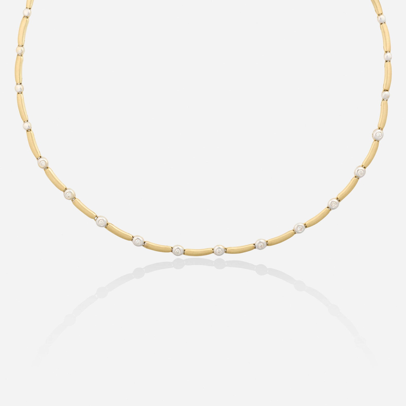 Diamond and bicolor gold necklace: Diamond and bicolor gold necklace Designed with curved links spaced by round brilliant-cut diamonds 14k yellow and white gold 15.50 in; Gross weight 11.5 dwts This work will ship from Lambertville, Ne